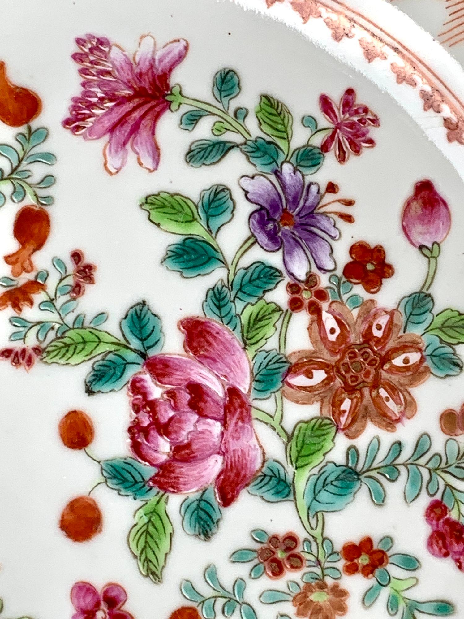 This set of four Chinese porcelain dishes are hand painted in Famille Rose colors.
The center is filled with beautiful flowers separated by leaves in two tones of green.
The predominant colors are pink, orange, green, and turquoise with small