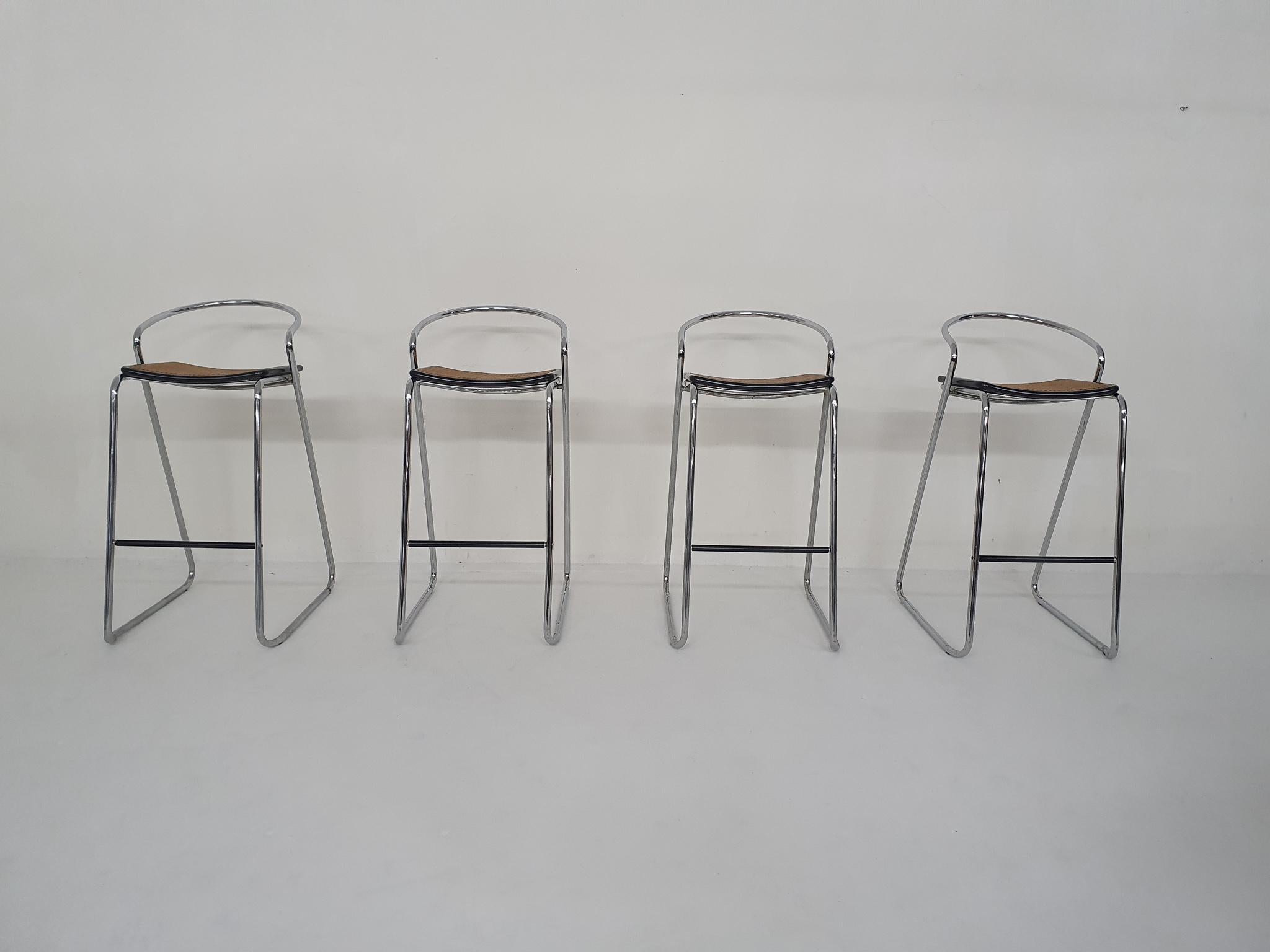 Set of four tubular chrome bar stools with webbing seats, inspired by the cesca chairs of Marcel Breuer.
In good condition, some rust spots on the frames.