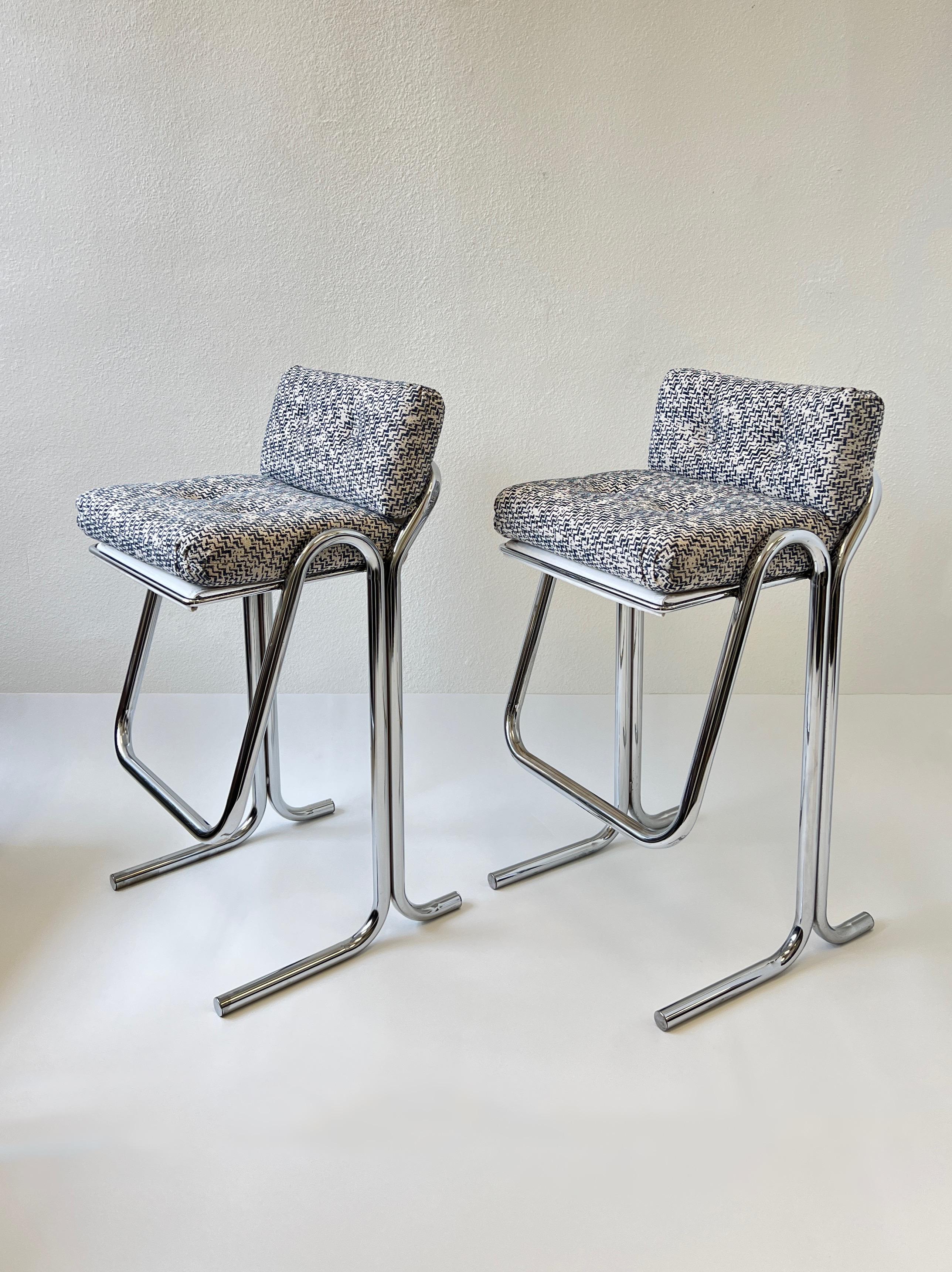 1970’s Set of four polish chrome barstools by Jerry Johnson. 
Newly recovered in a beautiful blue and off white fabric, the frames are beautiful vintage condition. 
Measurements: 20.5” wide, 20” deep, 39.5” high, 32” seat, 12” footrest.