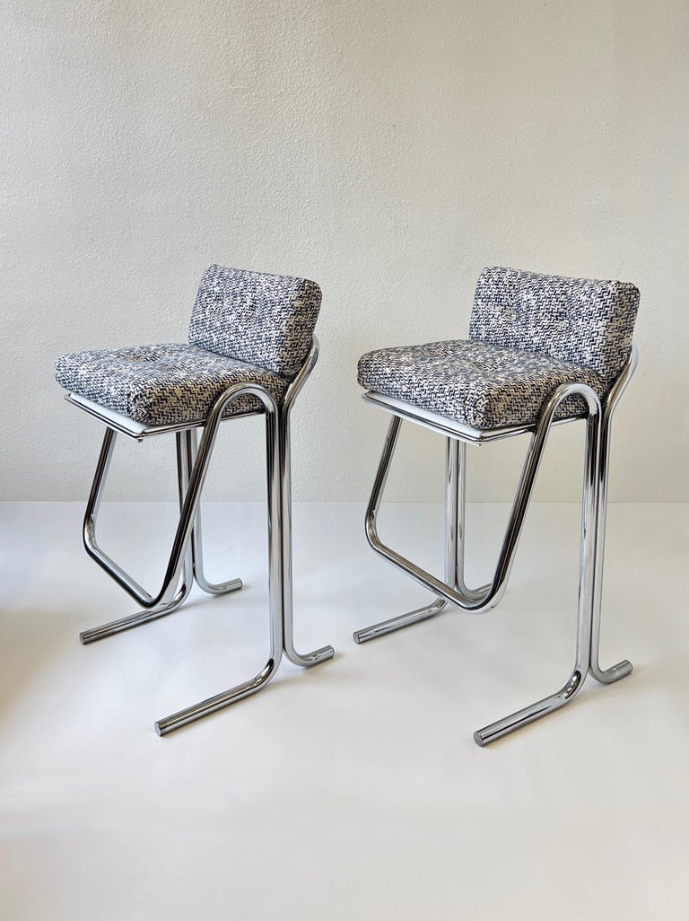 1970’s Set of four polish chrome barstools by Jerry Johnson. 
Newly recovered in a beautiful blue and off white fabric, the frames are beautiful vintage condition. 
Measurements: 20.5” wide, 20” deep, 39.5” high, 32” seat, 12” footrest.
