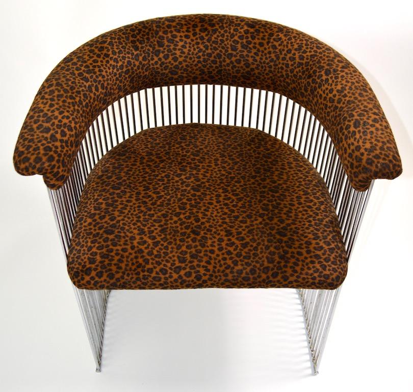 Stylish set of chrome rod tub chairs with cheetah print fabric upholstery. The chairs feature repeating vertical rods which constitute the frame, and an upholstered back rest and seat. Design reminiscent of Verner Panton - The chrome rods show some