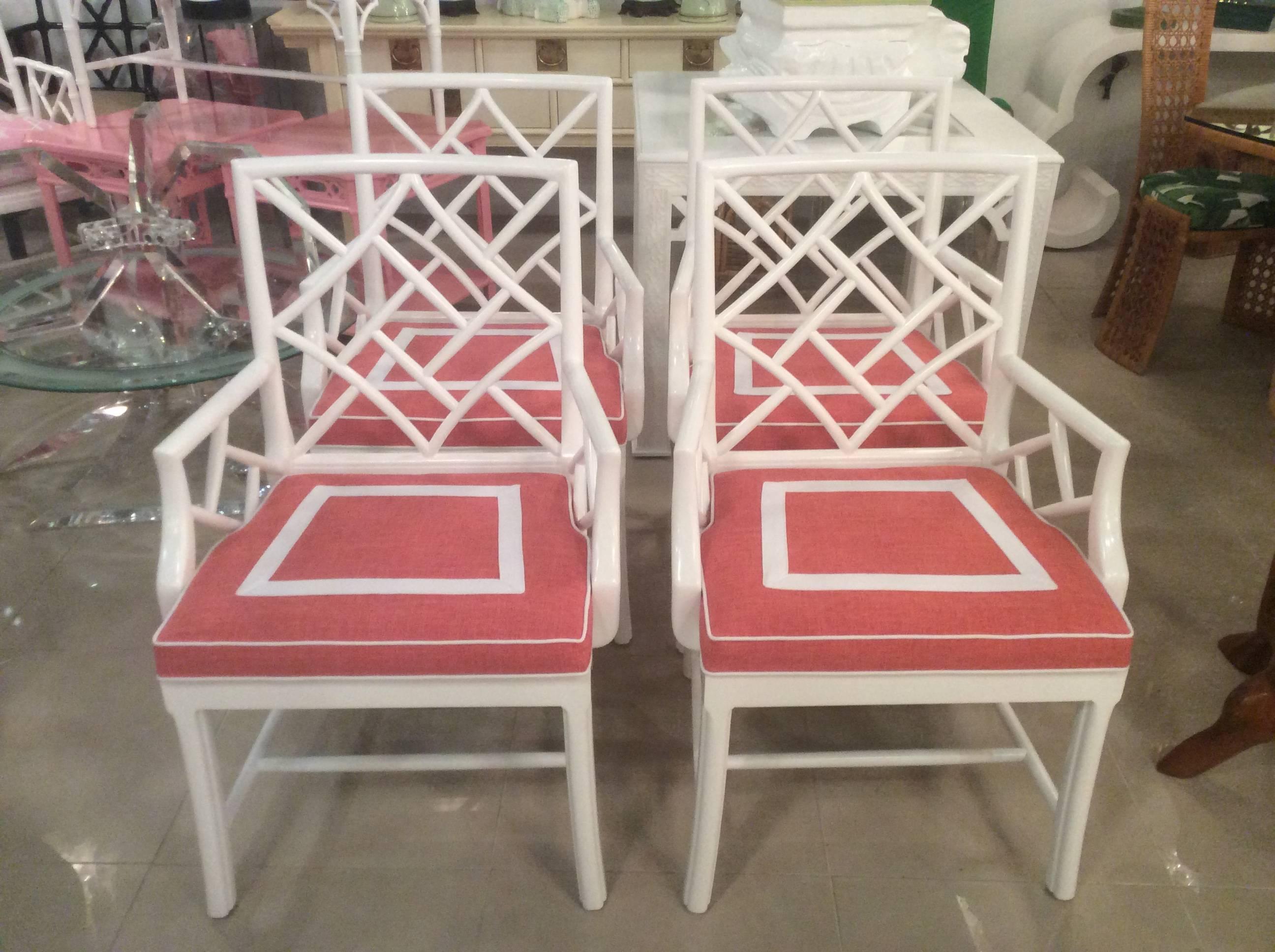 Beautiful set of 4 vintage Chinese Chippendale Cockpen dining room arm chairs in a newly lacquered white gloss finish. Custom newly upholstered cushions with a coral linen fabric and white box inset. Perfect for a Palm Beach decor! 