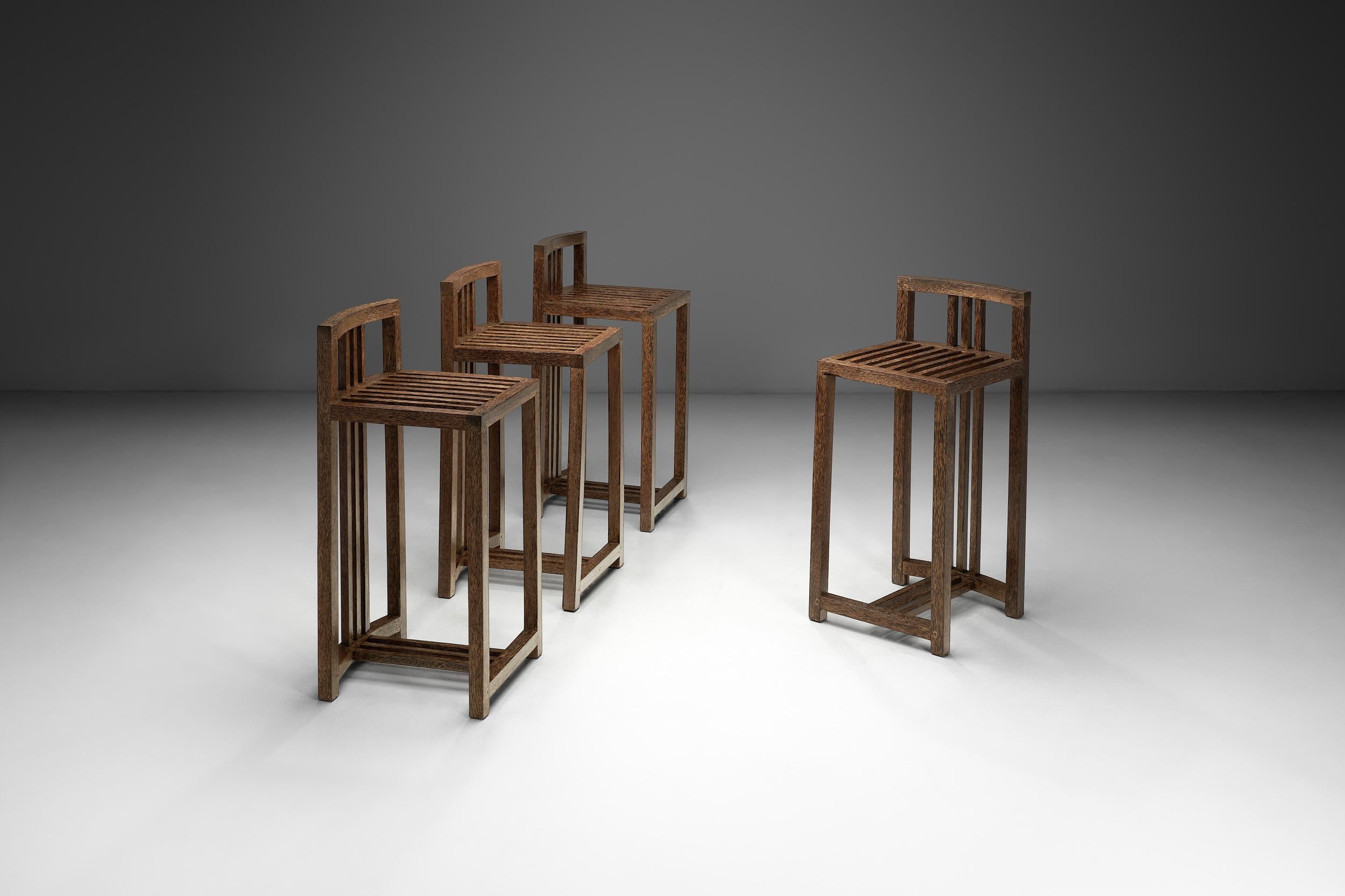 An artistic flair is apparent with this set of four bar stools. The design uses elements of geometry to create a unique look based on the natural qualities of wood. This set’s structural precision also stands as evidence of why many European