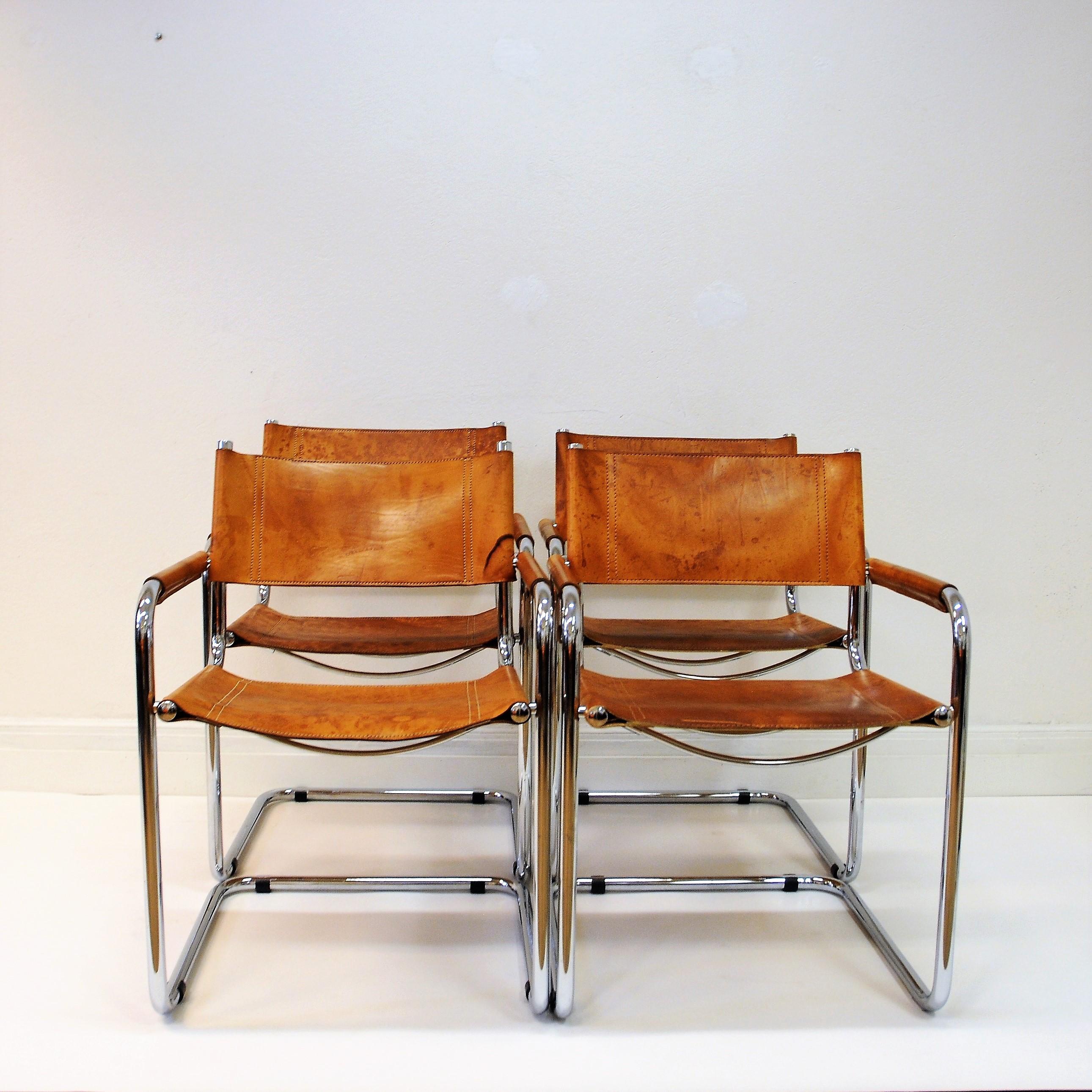 Four beautiful armchairs in cognac leather by designer Mart Stam for Fasem- Italy. The leather seats and backrests are supported by tubular frames. The chairs have a cantilevered tubular metal frame with cognac leather seating and backrest. The