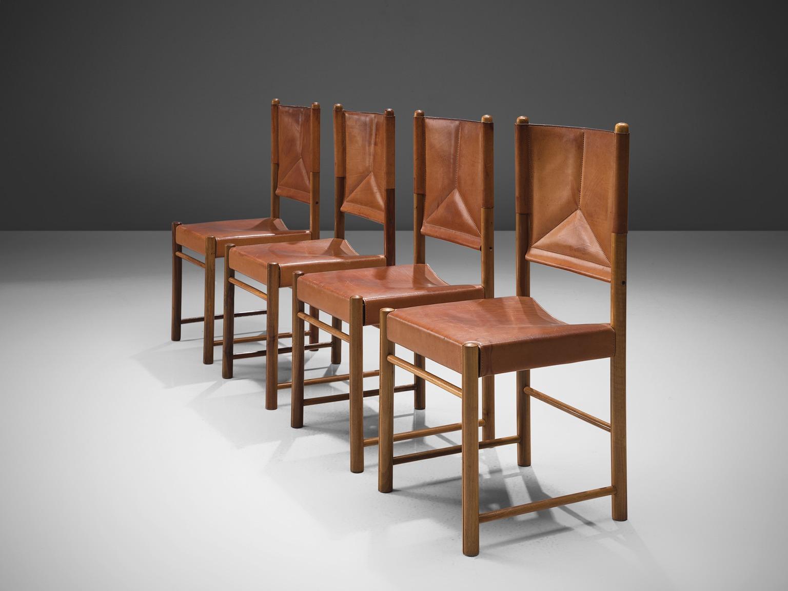 Set of four dining chairs, cognac leather, beech, Italy, circa 1960.

This set of four cognac leather dining chairs are stately and refined. The detailing and finish in this set of chairs is very high. The tripod stitched pattern on the back is