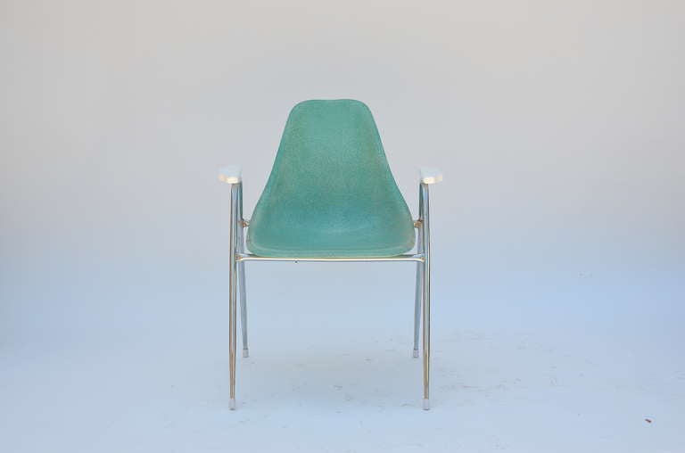 Set of 4 comfortable turquoise fiberglass armchairs on chrome bases.