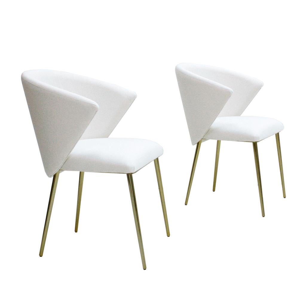 Set of four contemporary modern chairs made with solid wood structure, white upholstery and four brass legs. Italian manufacture.