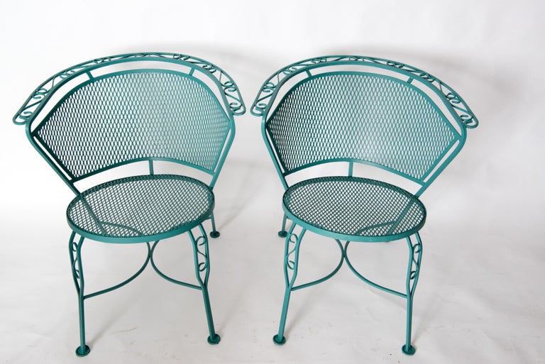 Set of four wrought iron and metal mesh curved back dining chairs, possibly by Woodard. Round mesh seats.
Comfortable curved backs. Freshly painted in sea green.