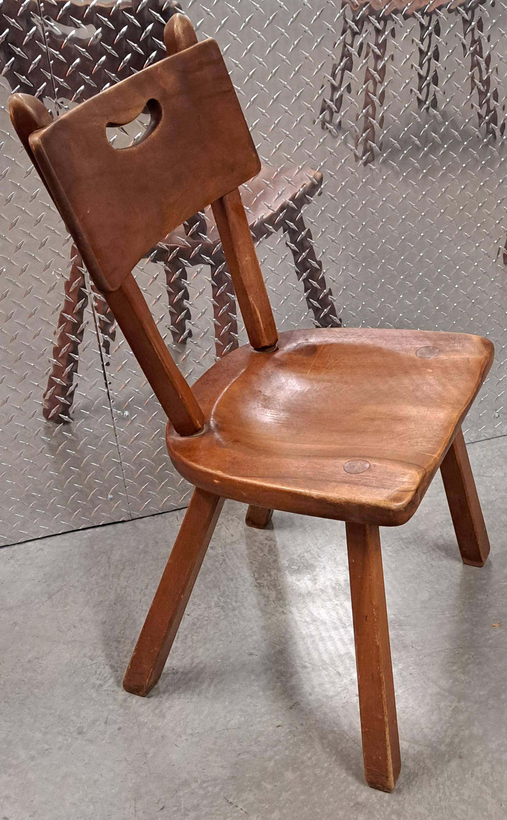 Set of four Herman DeVries for Cushman Furniture colonial style carved wood chairs. With the Cushman bronze label and authentication stamped under the seat. Very sturdy chairs will last many generations.