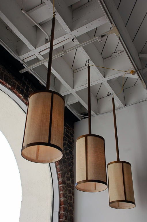 Set of Four 'Cylindre' Patinated Brass and Raffia Pendant Lights, Design Frères In Excellent Condition For Sale In Los Angeles, CA
