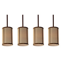 Lot de quatre Lights 'Cylindre' en laiton patiné et raphia par Design Freres