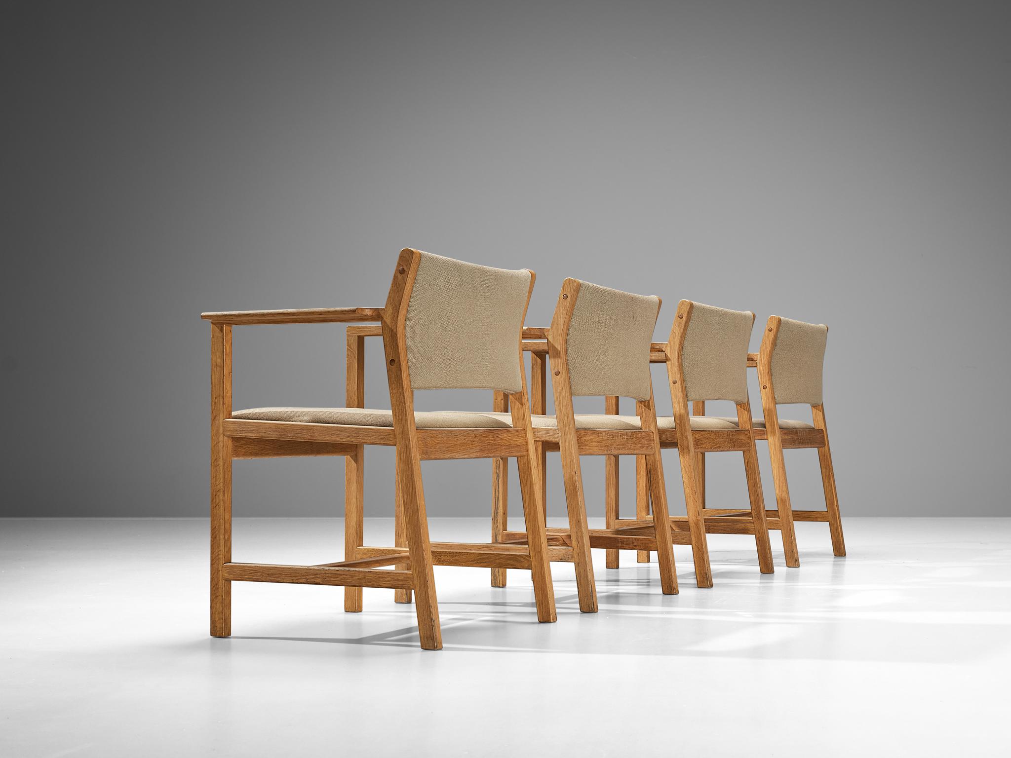 Staten Kontrol Møbler, armchairs, oak, fabric, Denmark, 1960s. 

Set of four Danish armchairs manufactured by Staten Kontrol Møbler. Theis model with a rounded seat has a characteristic, sculptural frame. The tilted rear legs with sharp edges