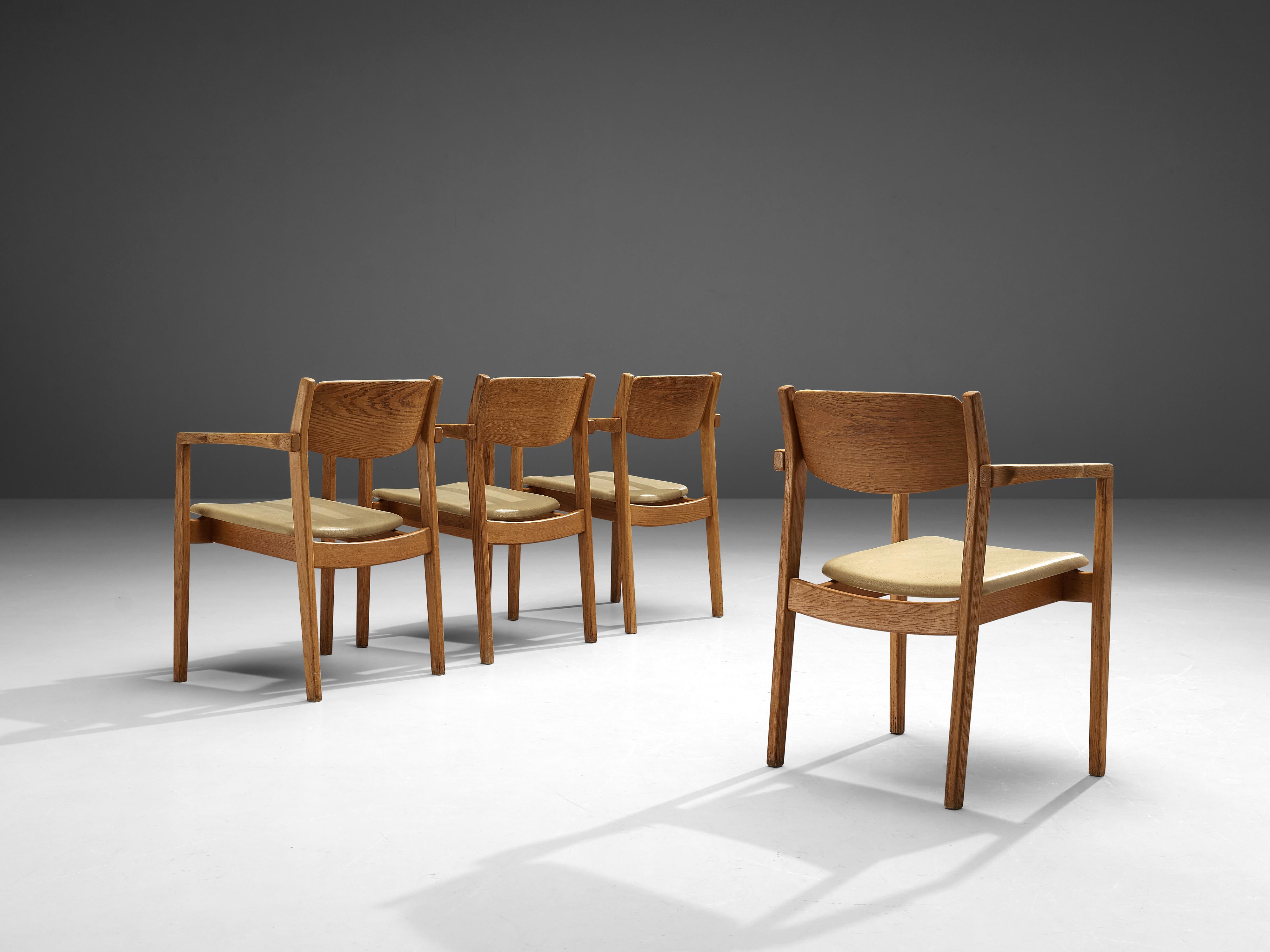 Set of four armchairs, oak, leatherette, Denmark, 1960s

Set of four sculpted dining chairs in solid oak and leatherette upholstery. These chairs show the characteristics of well-crafted furniture. Wood joints are shown at the armrests and highlight