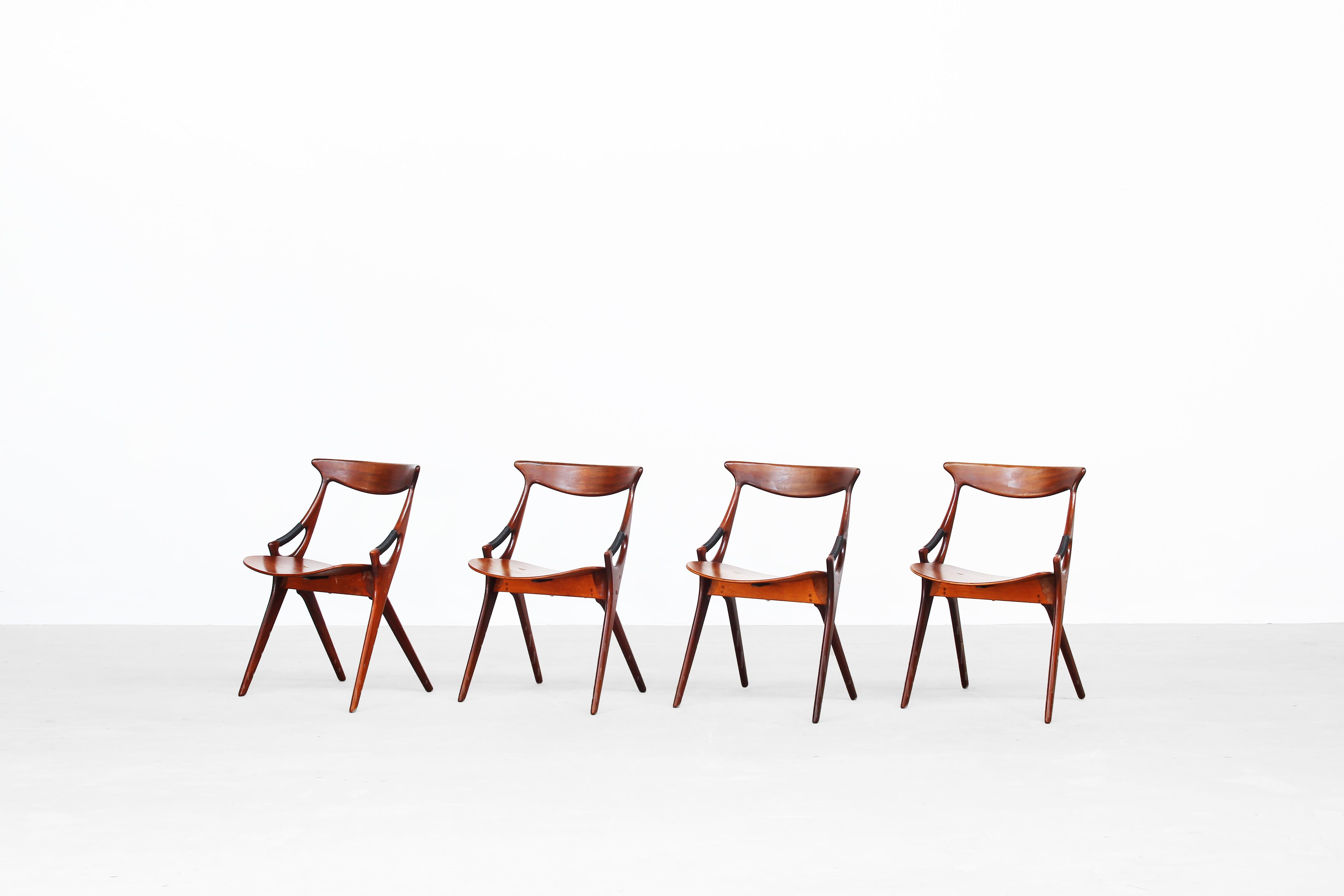 Set of four dining chairs designed by Arne Hovmand-Olsen and produced by Mogens Kold, Denmark 1959.

This rare model by Mogens Kold is a harmonic symbiosis of sculptural form and function. All four chairs were professionally restored and are in a
