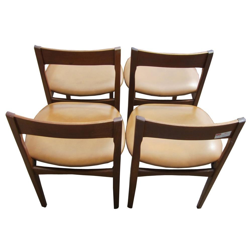 A set of four Danish dining chairs with beige cushions and tapered legs. A comfortable and stylish example of Mid Century Danish Modern design.

