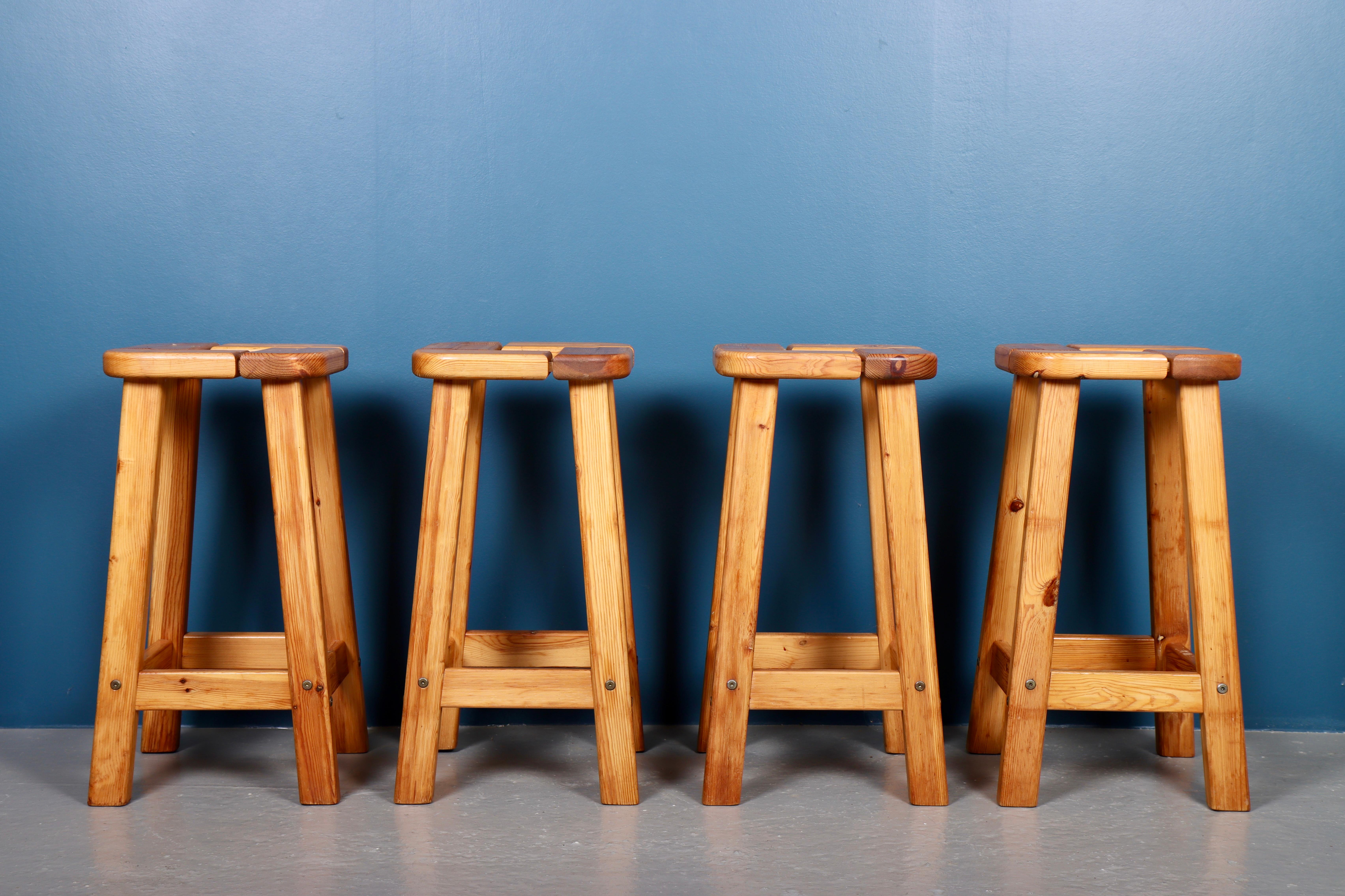 Set of four great looking high stools in solid pine. Perfect for a bar or in the kitchen. Made in Findland in the 1960s. Great condition.