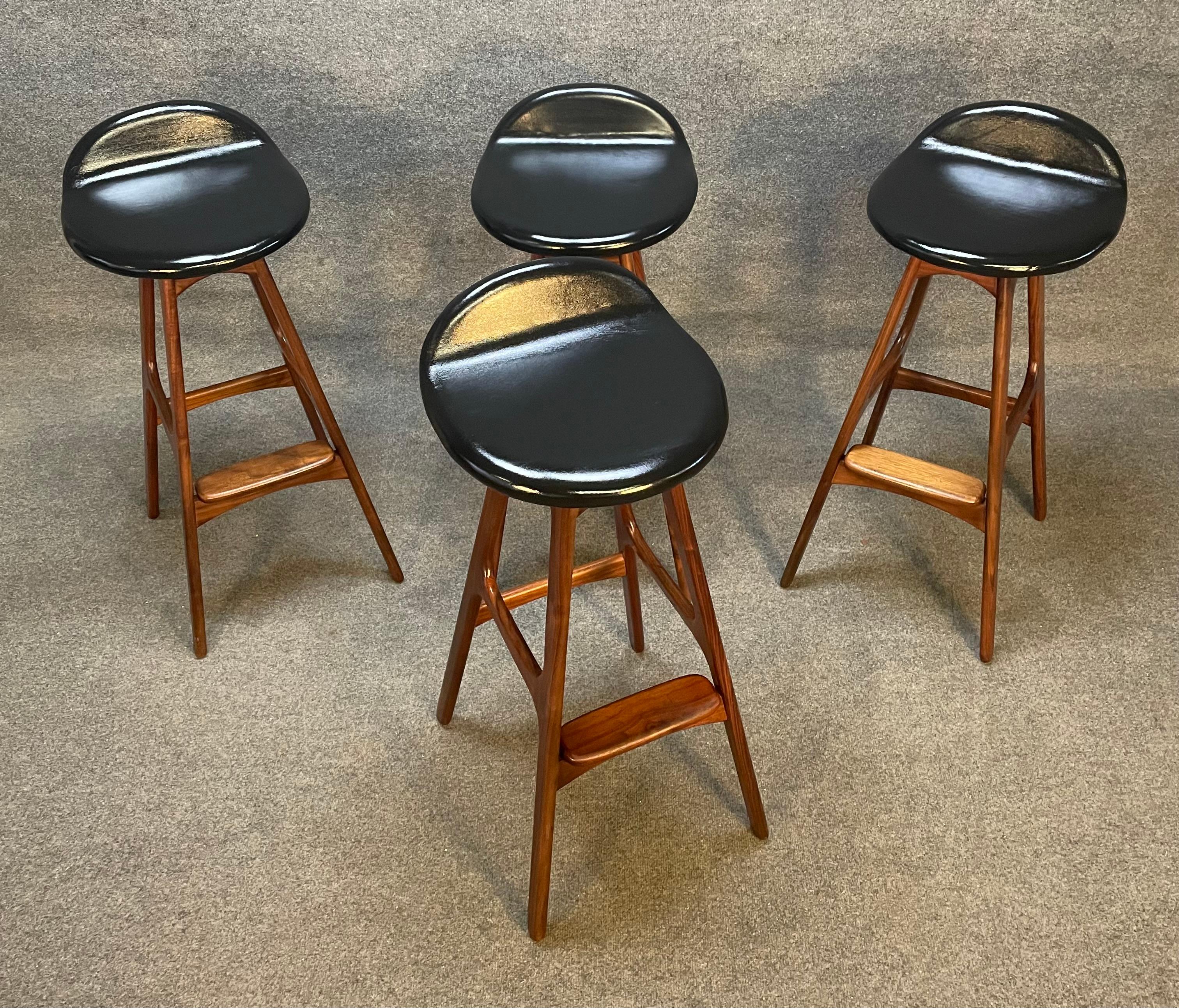 Here is a set of four Scandinavian Mid-Century Modern bar stool in solid walnut designed by Erik Buch and manufactured by Odense Mobeklfabrik in Denmark ion the 1960's.
These four comfortable stools, recently imported from Europe to California