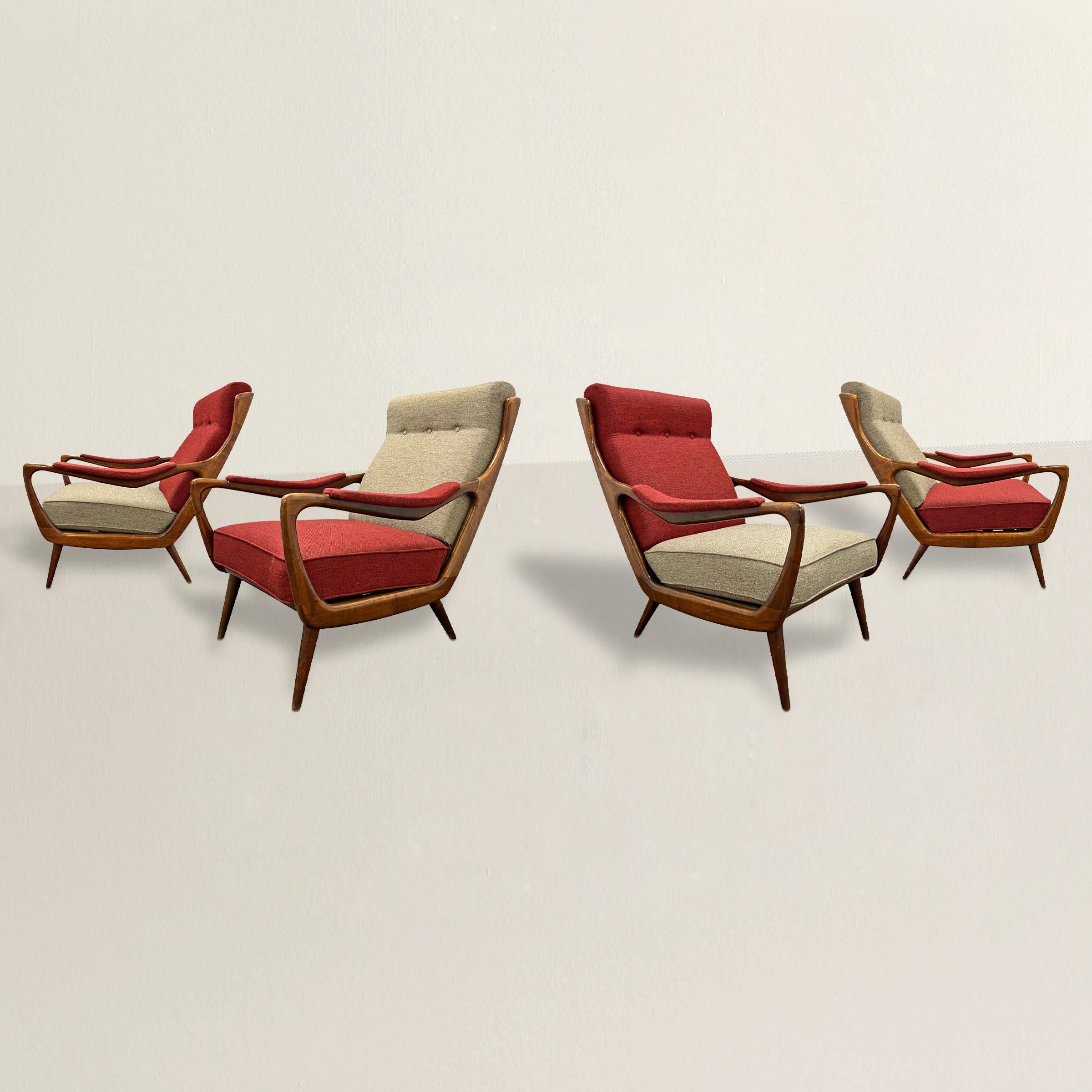 A trendy and tony set of four 1950s Danish Modern lounge chairs with highly stylized wood frames with continuous arms, resting on four tapered turned wood legs, and retaining their original alternating gray and red wool upholstery.  Perfect for your