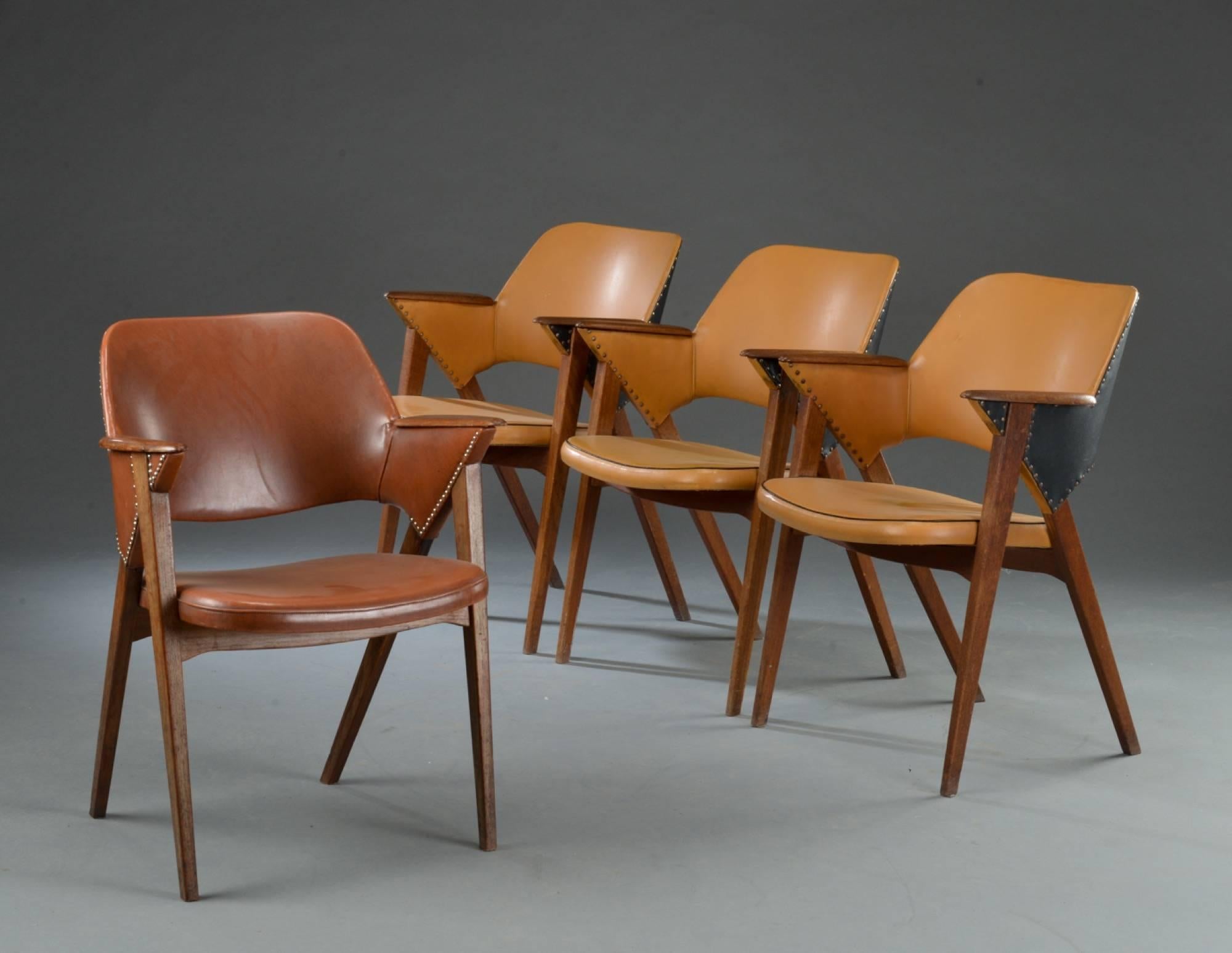 Set of four armchairs with teak seat and backrest. Seat and back upholstered with stitched leather. Danish furniture manufacturer, 1960s.