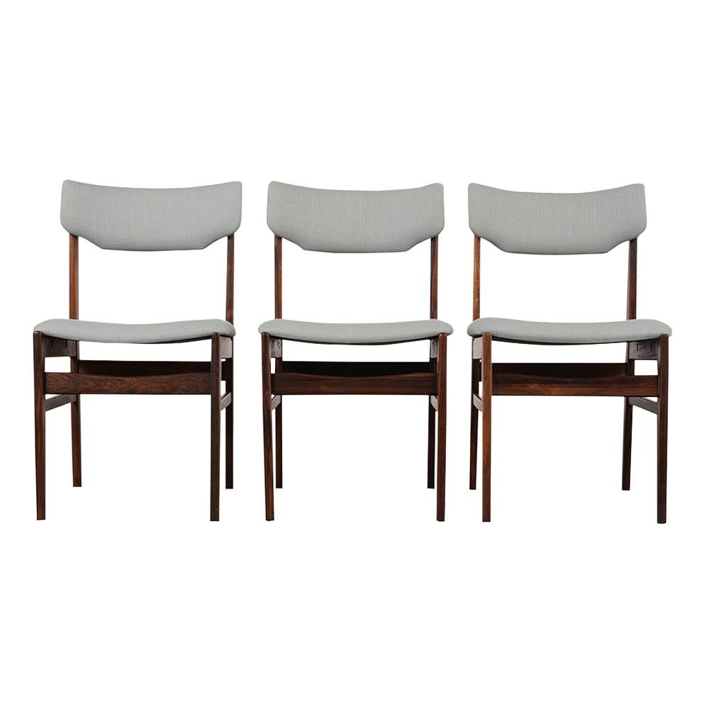 This set of four 1960s Danish Mid-Century Modern Dining chairs has been newly restored, is made out of rosewood, and comes with a satin lacquered finish. The chairs feature a curved backrest, seats that have been professionally reupholstered in a