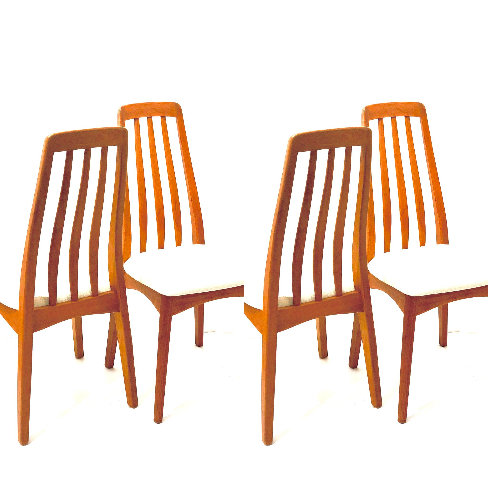 Beautiful elegant tall back set of four chairs in solid teak, circa 1970s solid and sturdy frames in great condition with new cream color fabric seat pads.