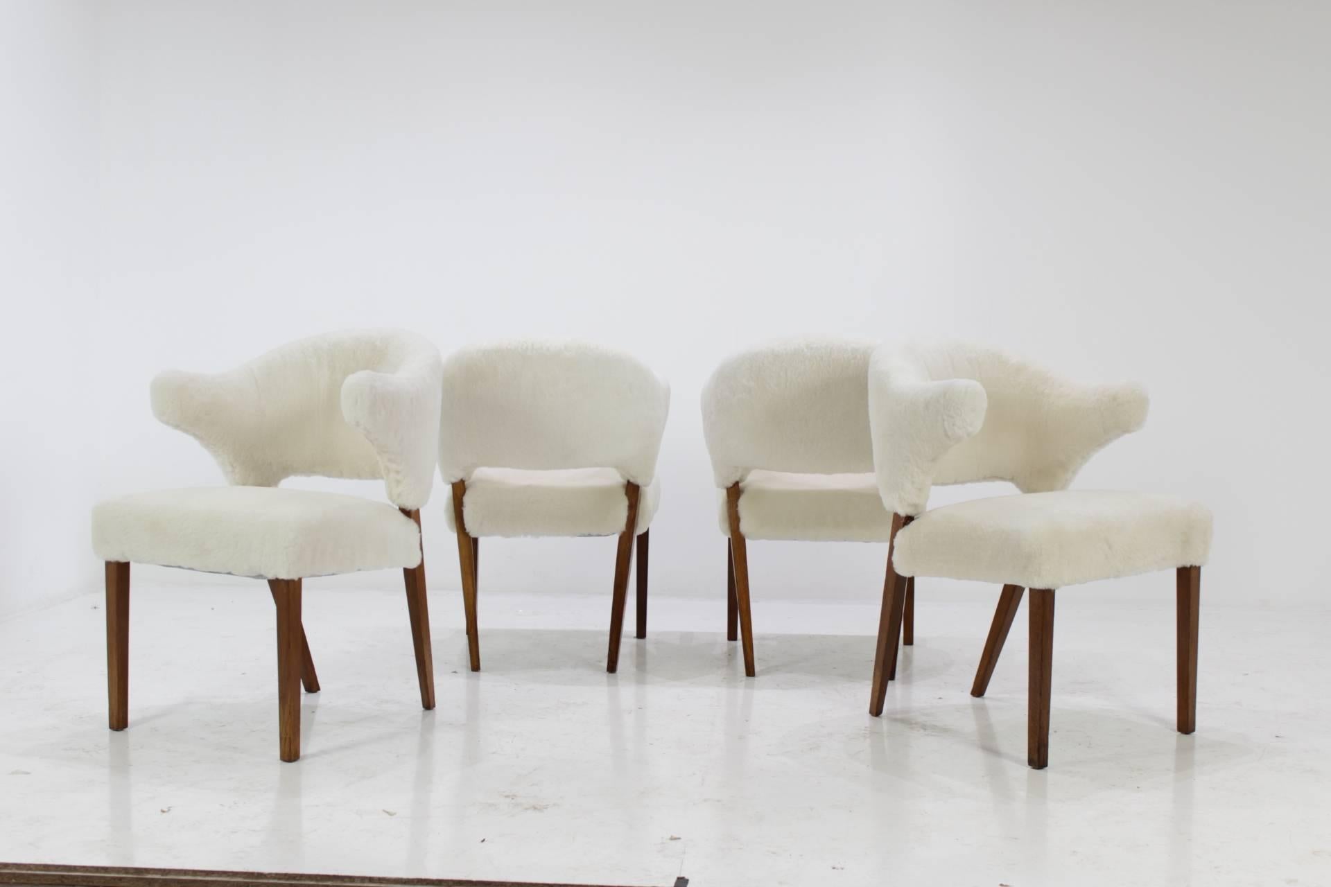 Danish oak armchair with sheepskin upholstery, 1960s. These set of four armchairs have new non chemically treated sheepskin upholstery on oak frame. Those chairs are very comfortable.