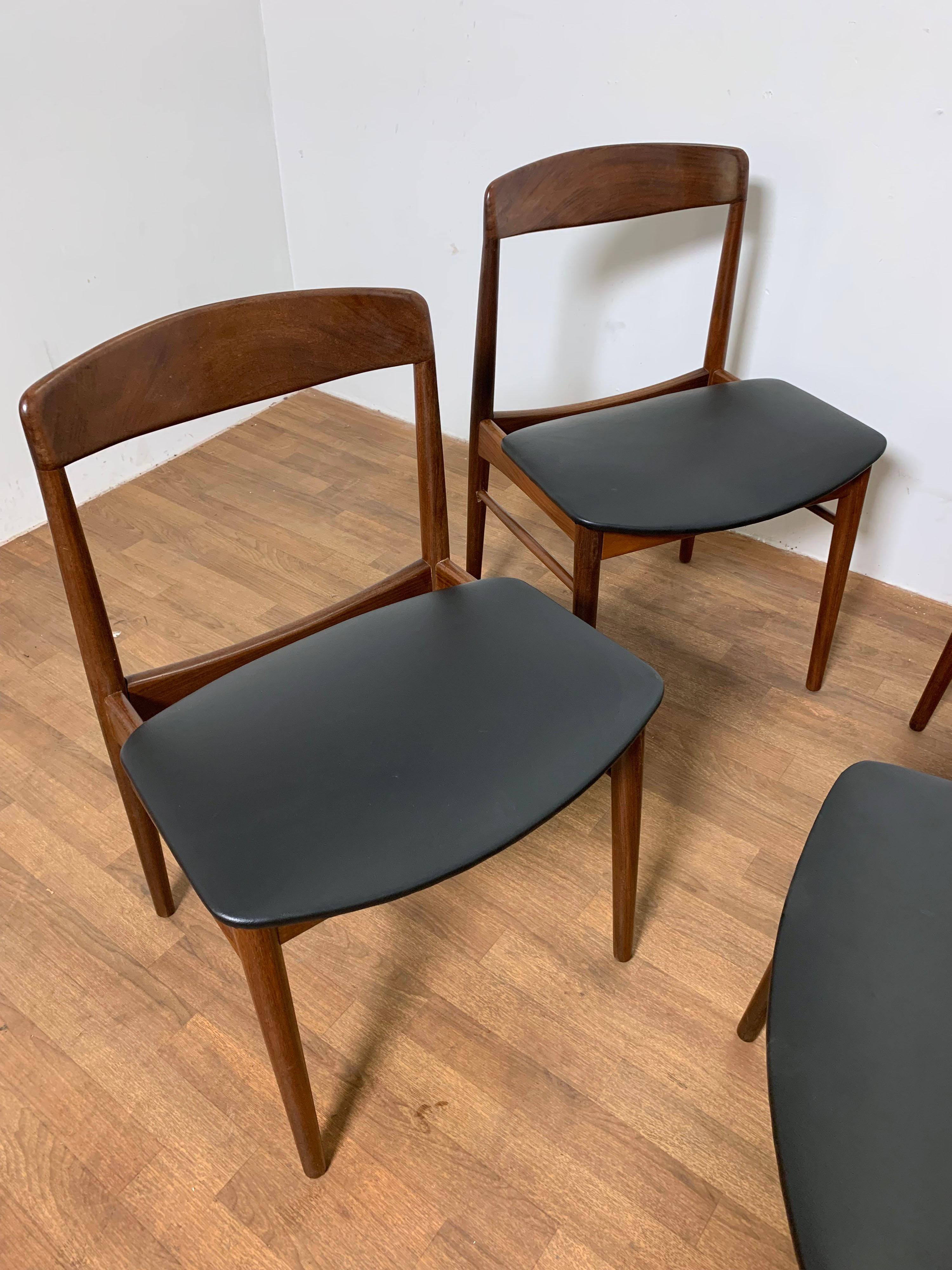 Set of four teak dining chairs with solid carved backs, by SAX (Saxkjobing Savvaerk Stolefabrik), made in Denmark, circa 1960s.