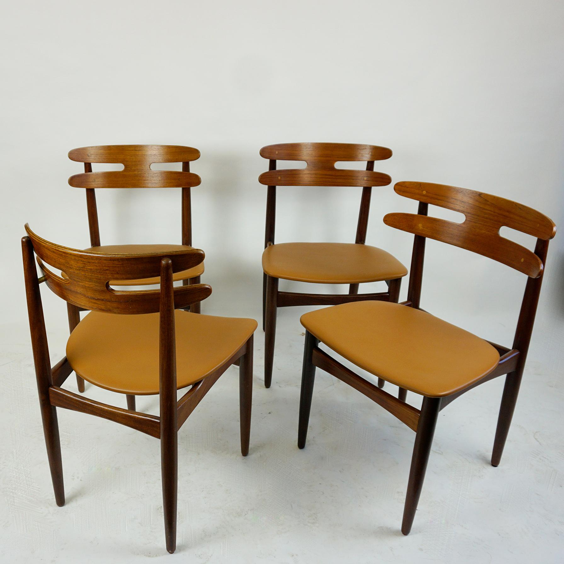 This rare set of organic shaped four Scandinavian Modern teak dining chairs is designed by Johannes Andersen in the 1960s and produced by Bramin Mobler, mod. no 178. They feature solid teak wood frames and moulded teak veneer backrests with brass