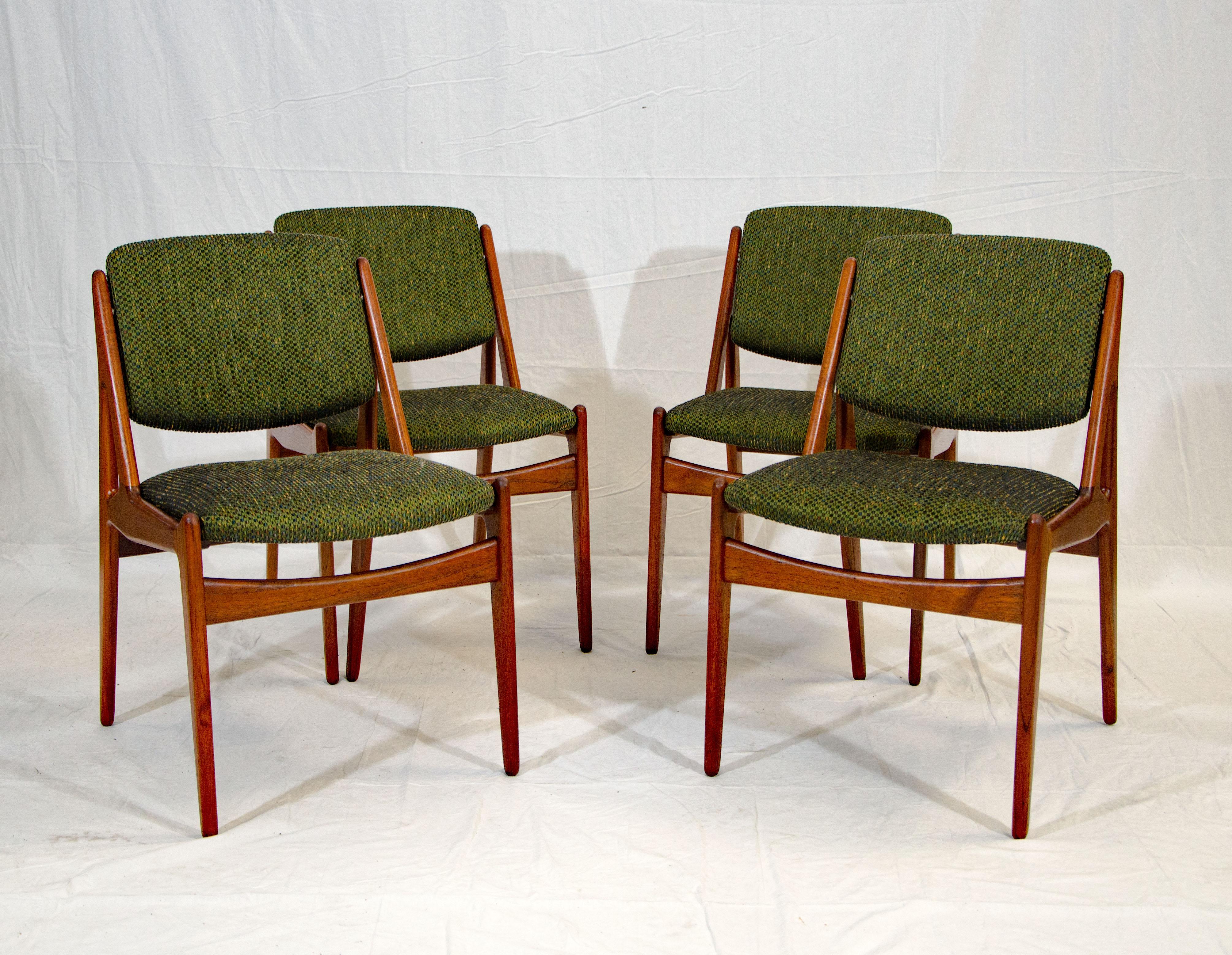 This set of four Danish teak Ella dining chairs have a great side profile and swiveling backs which adjust to your sitting position. They are sturdy and comfortable. The main fabric color is dark green with a few other color specks woven in.