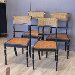 Set of Four Diminutive English Regency Ebonized and Caned Side Chairs
