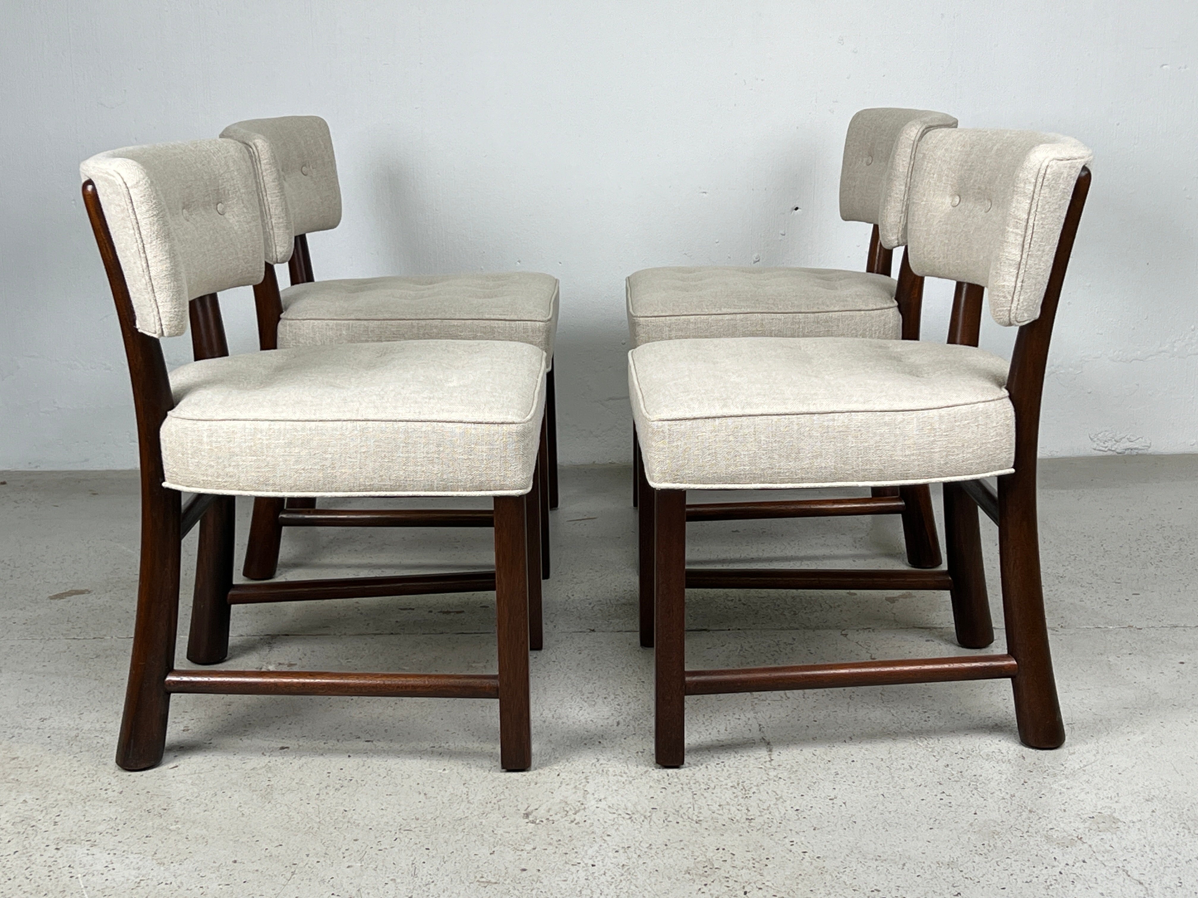 A set of four curved back dining chairs with mahogany frames. Designed by Edward Wormley for Dunbar.