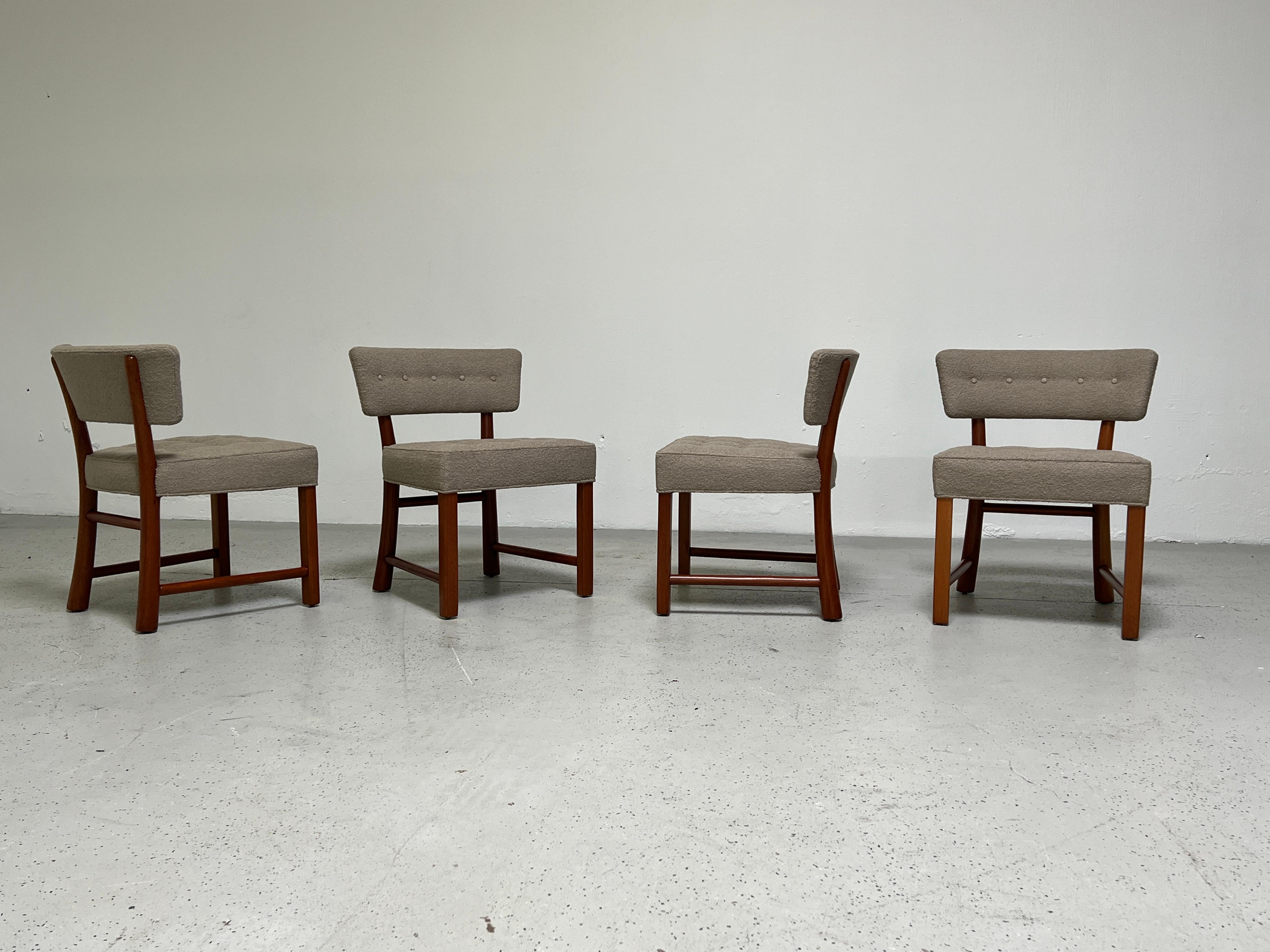 A set of four curved back dining chairs with mahogany frames. Designed by Edward Wormley for Dunbar.