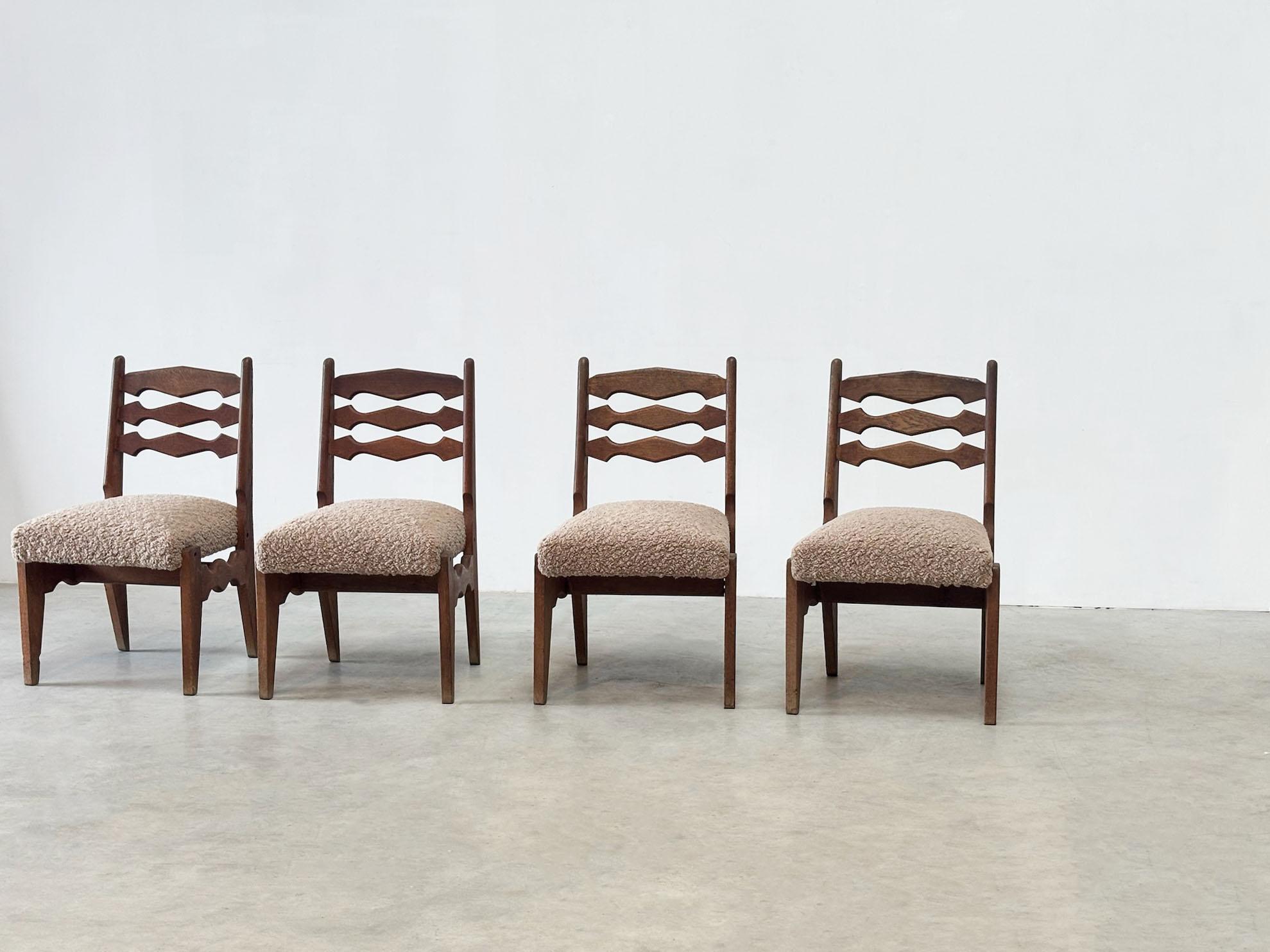 Beautiful and very rare set of 4 chairs by the famous designers Guillerme & Chambron. These chairs are from the 70s from france. They have an oak frame and a boucle fabric seating. Guillerme & Chambron are best known for there chairs and lounge