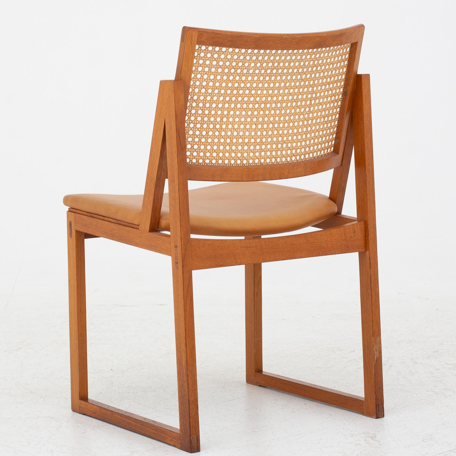 Four dining chairs in mahogany and rattan with leather seat. Maker Søborg Møbelfabrik.
