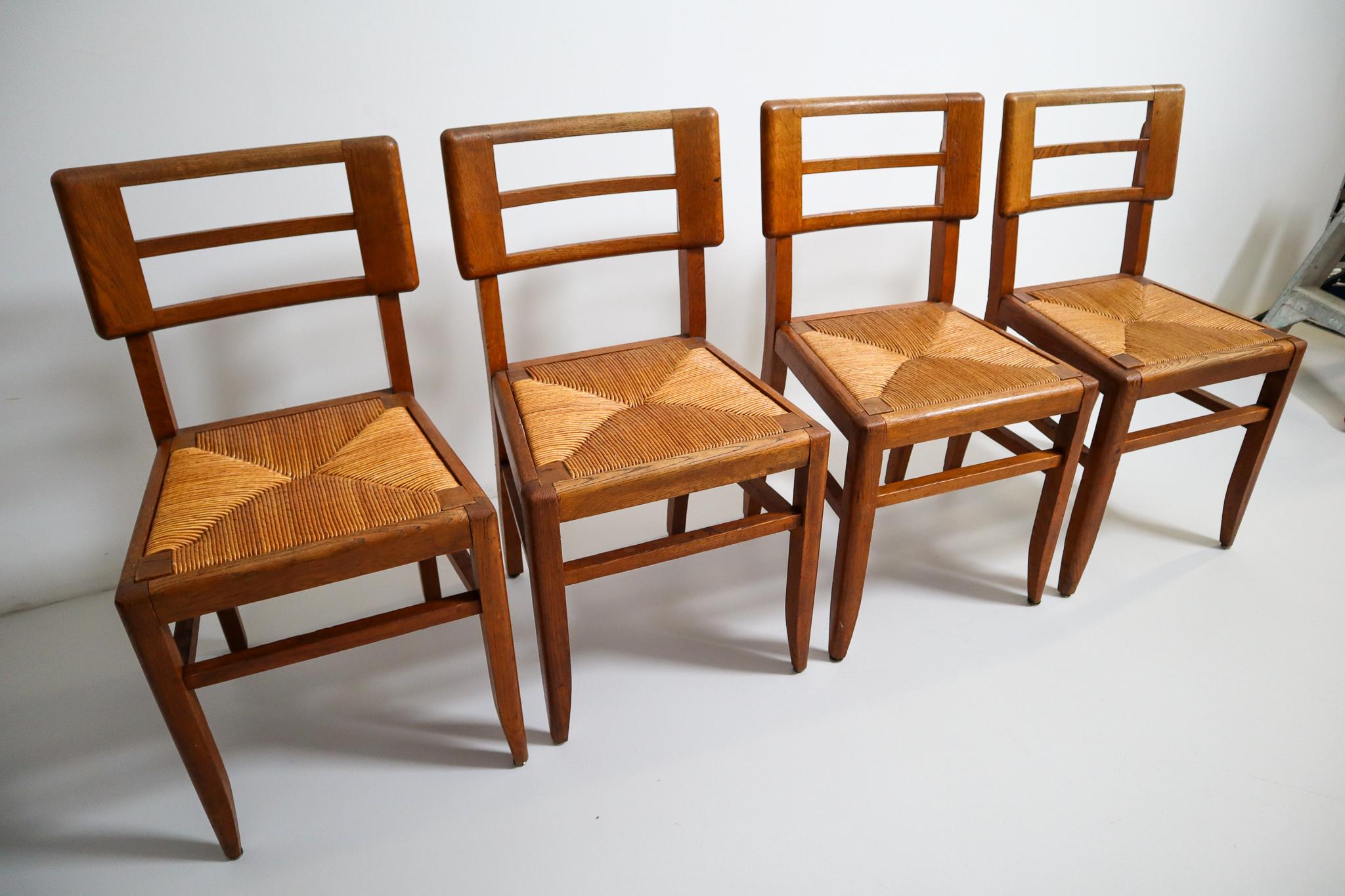 Mid-Century Modern Set of Four Dining Chairs by Pierre Cruege in Oak and Cane, France, 1940s For Sale