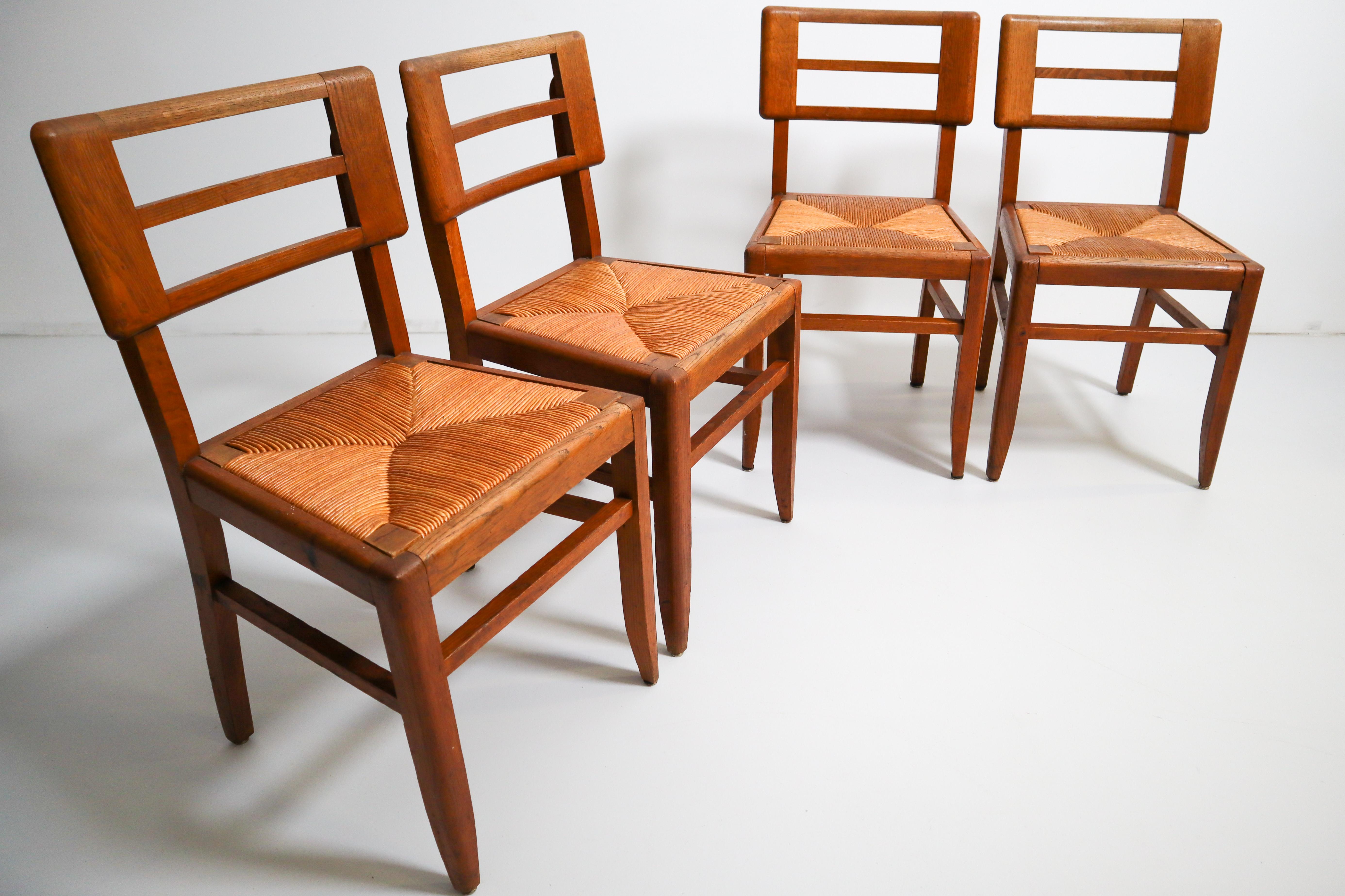 French Set of Four Dining Chairs by Pierre Cruege in Oak and Cane, France, 1940s For Sale