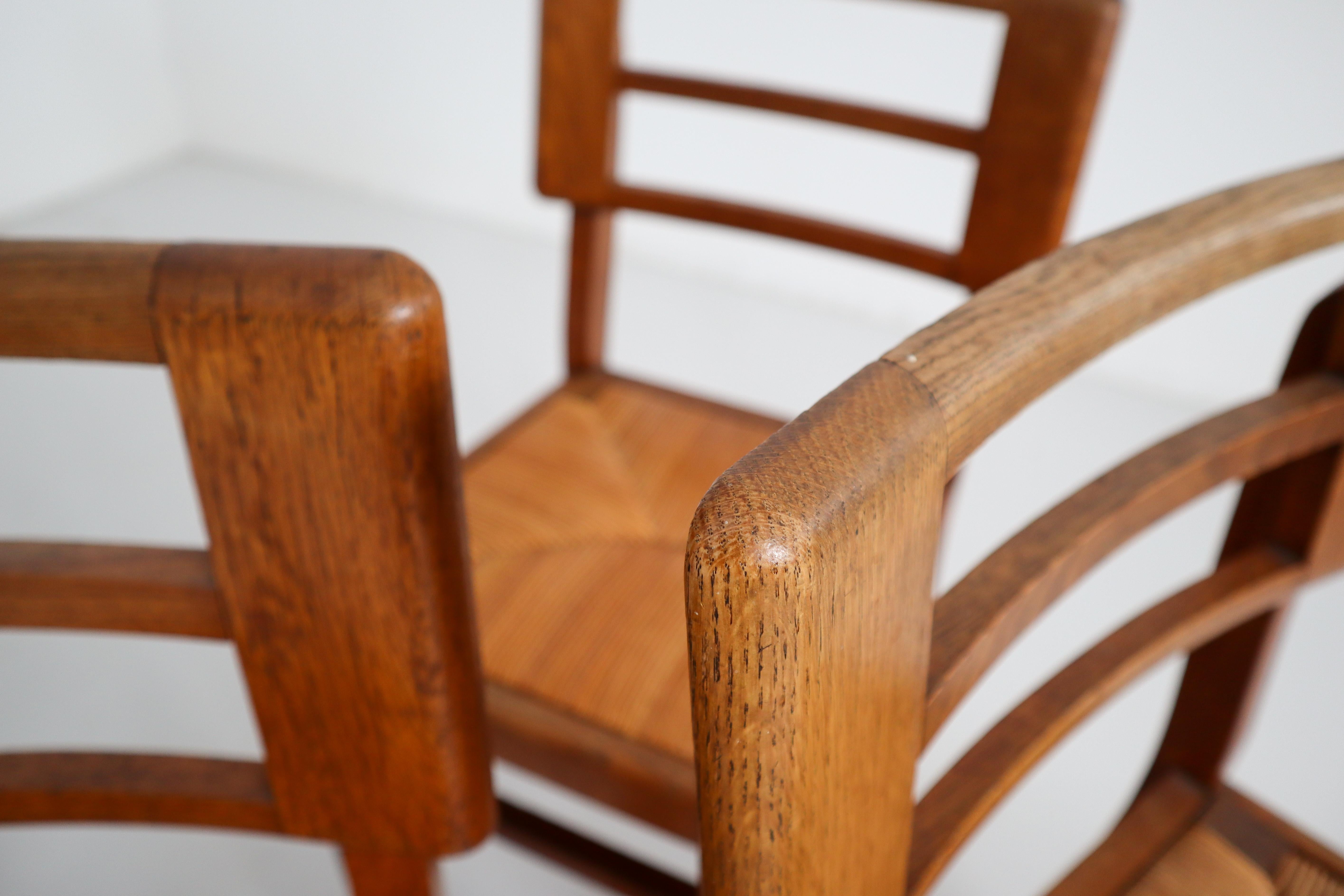 20th Century Set of Four Dining Chairs by Pierre Cruege in Oak and Cane, France, 1940s For Sale