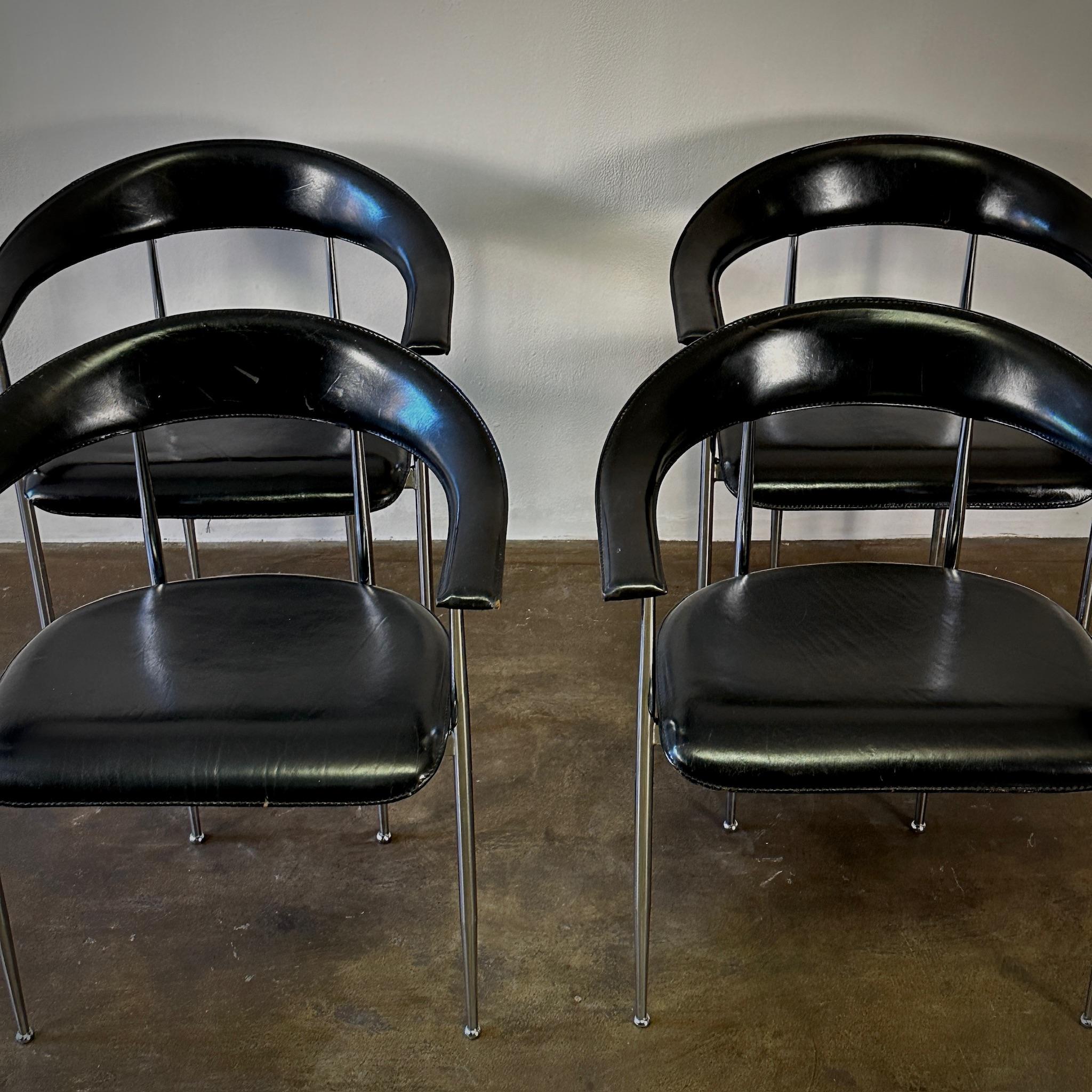 This set of four Italian armchairs by Fasem features a striking design with sleek chrome frames and black leather upholstery. The chairs' semi-circular shape and delicate silhouette embody the era's penchant for polished, modern aesthetics. These