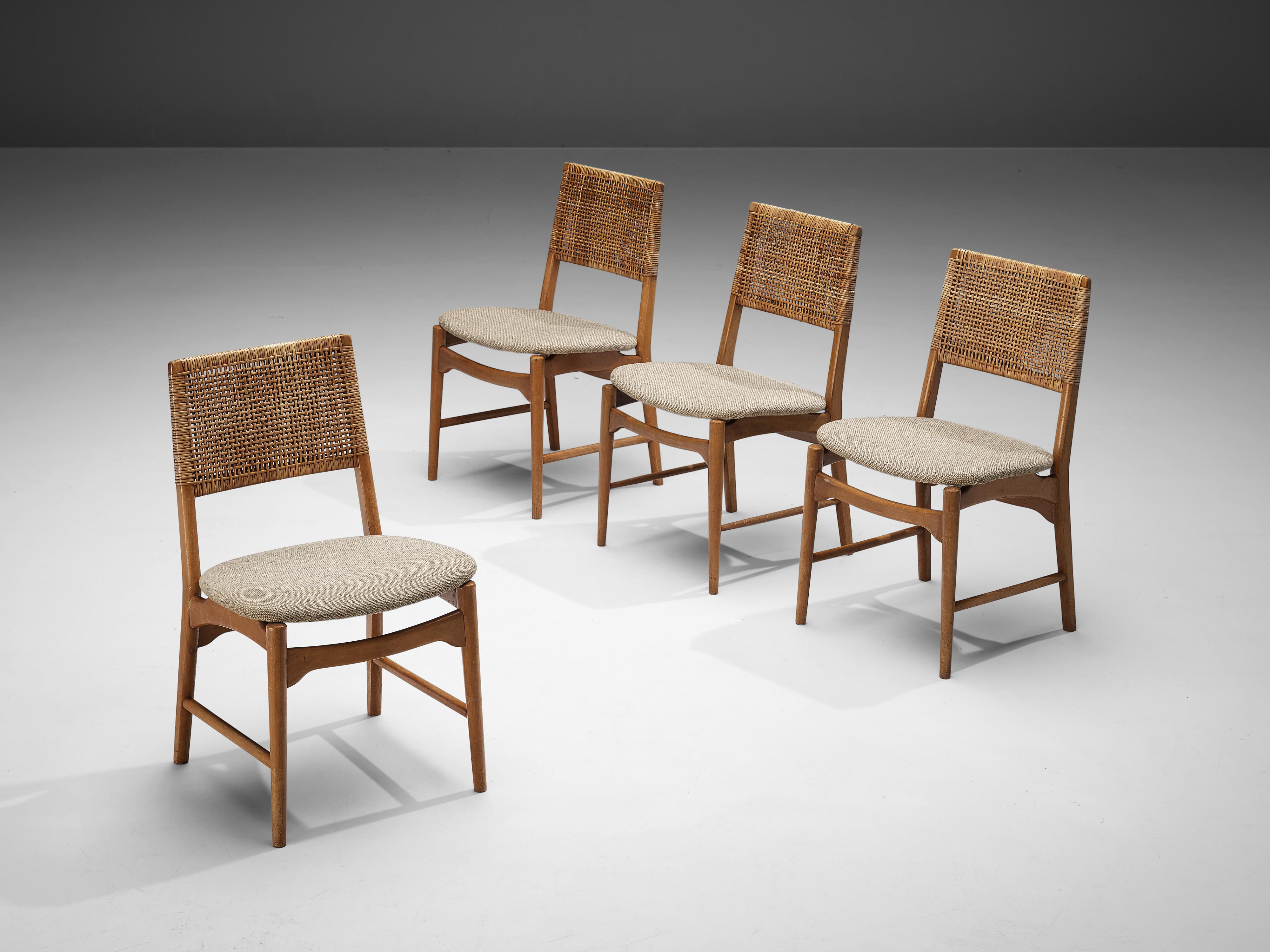 Set of four dining chairs, beech, natural fibre, fabric, Denmark, 1950s 

Elegant set of four dining chairs in solid beech and natrual fibre. This chair shows the characteristic Danish design. The tapered legs and sculptural legs, give it an open