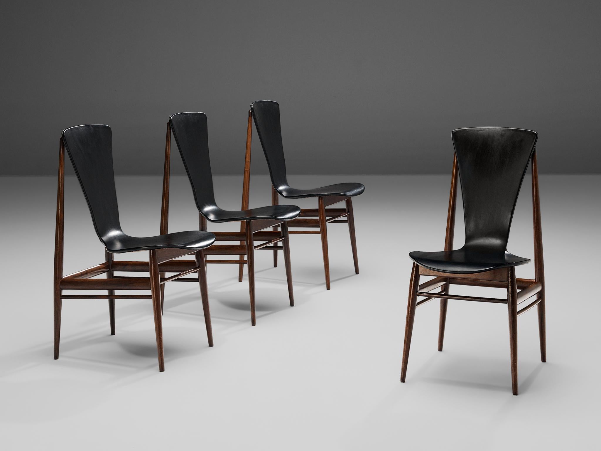 Set of four dining chairs, black leatherette, hardwood, Europe, 1960s

Elegant set of four dining chairs with strikingly airy design. A slim and tapered frame in tropical hardwood lifts up an hourglass shaped seating in black leatherette. The seats