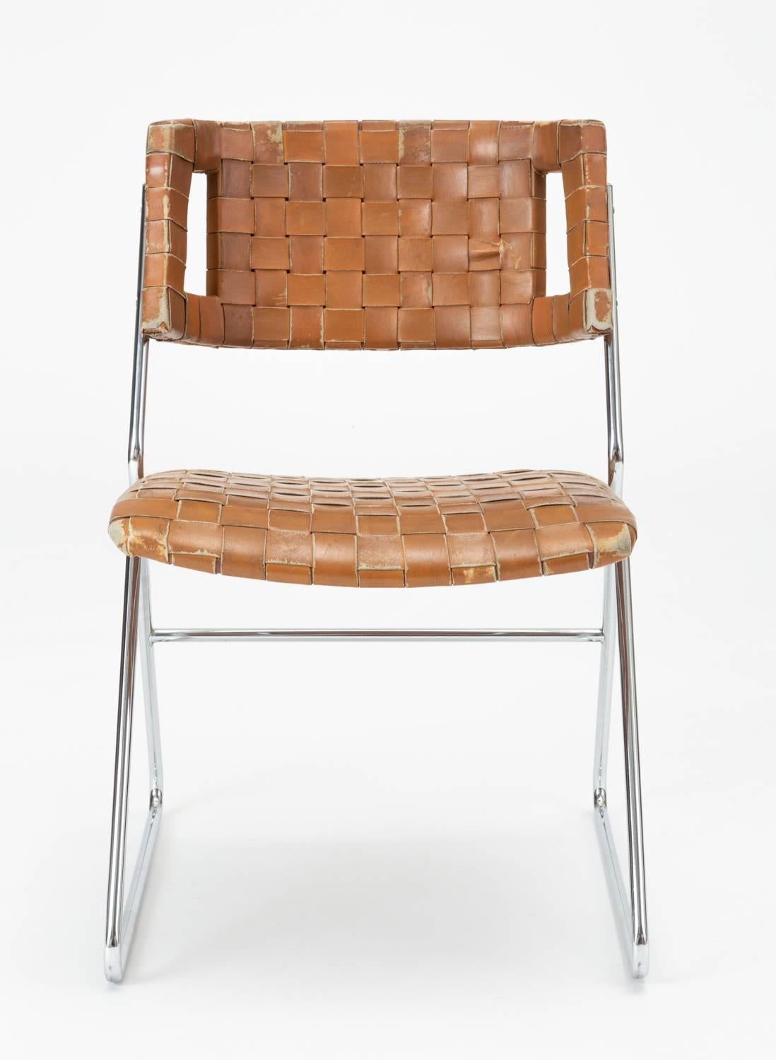 A set of four dining chairs from Missouri manufacturer Chromcraft. Designed in the 1970s, these sleek chairs have a sleigh base and narrow frame of chromed steel wire supporting a molded backrest and a seat cushion with rounded corners. Both back