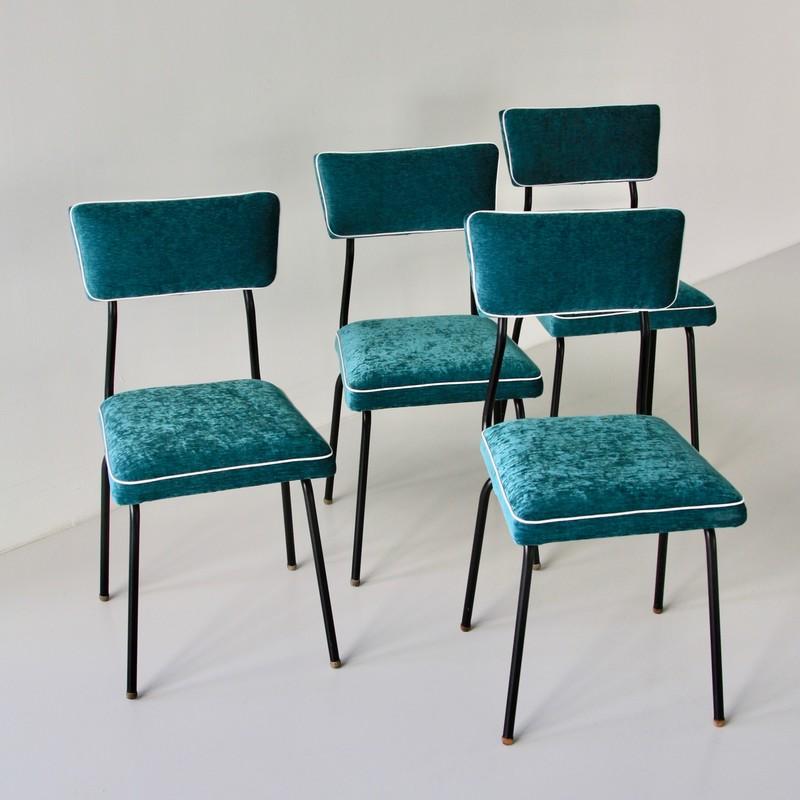 Set of four dining room chairs. France, 1950s.

Beautiful set of dining room chairs with metal frame painted in black, using round shaped wooden end pieces. Seat and back cushions upholstered in turquoise colored velvet with white borders. Seat