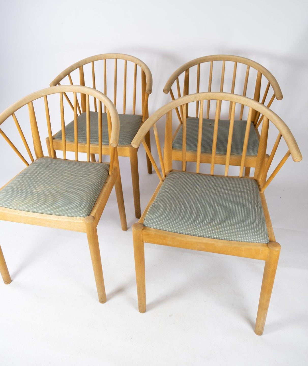 These Danish-designed dining room chairs from the 1960s showcase the timeless elegance and functional craftsmanship characteristic of mid-century modern design. Crafted from sturdy beech wood, renowned for its durability and warm, natural appeal,