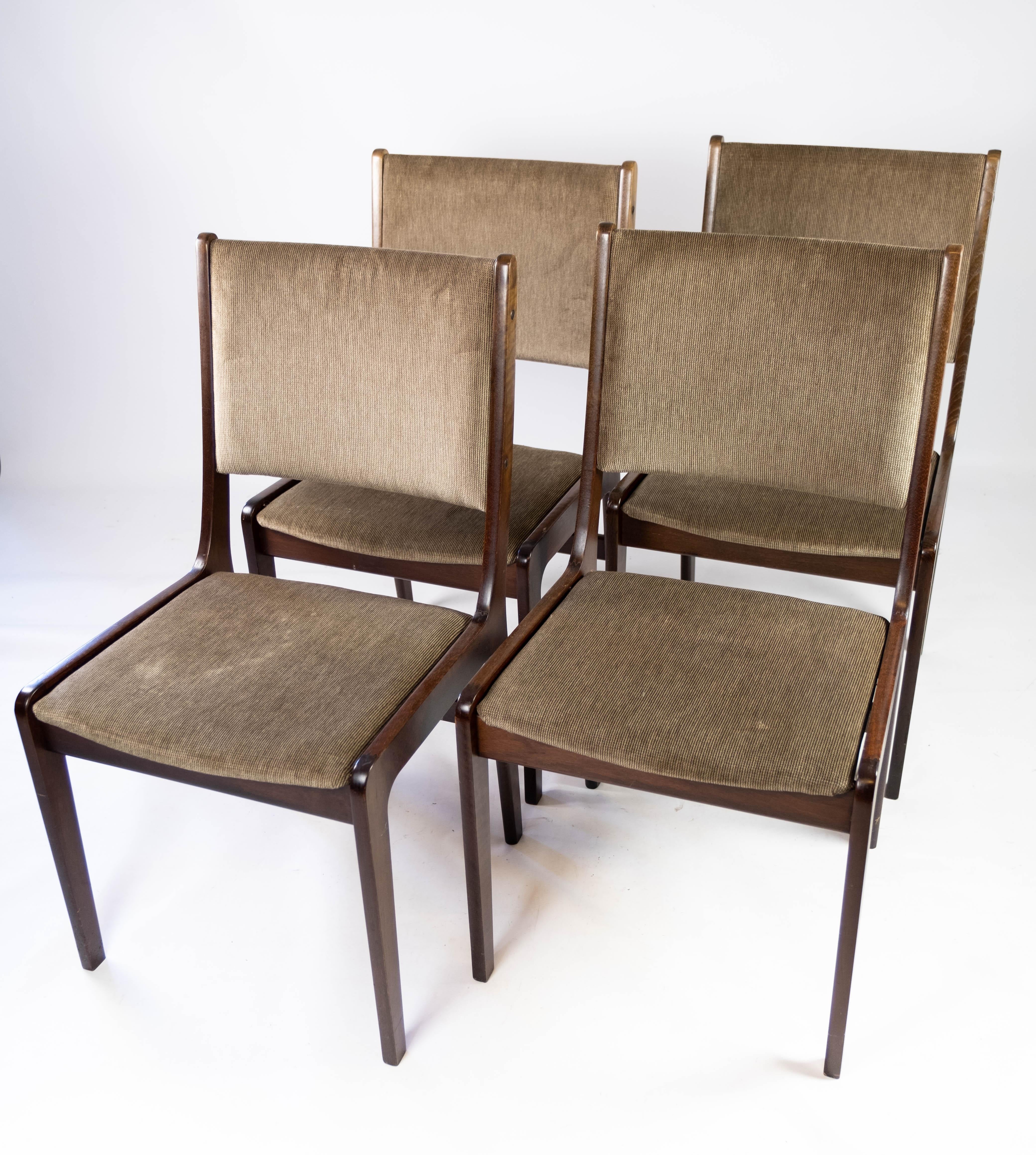 Set of four dining room chairs in dark wood and dark fabric of Danish design manufactured by Farstrup in the 1960s. The chairs are in great vintage condition.
 