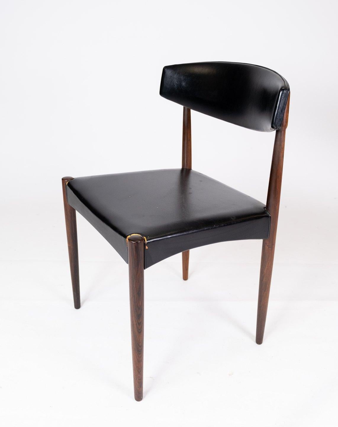 This set of four dining chairs is a beautiful example of Danish design from the 1960s. The chairs are made of rosewood, an exclusive wood known for its rich color and beautiful grain.

The elegant design combined with the luxurious black leather