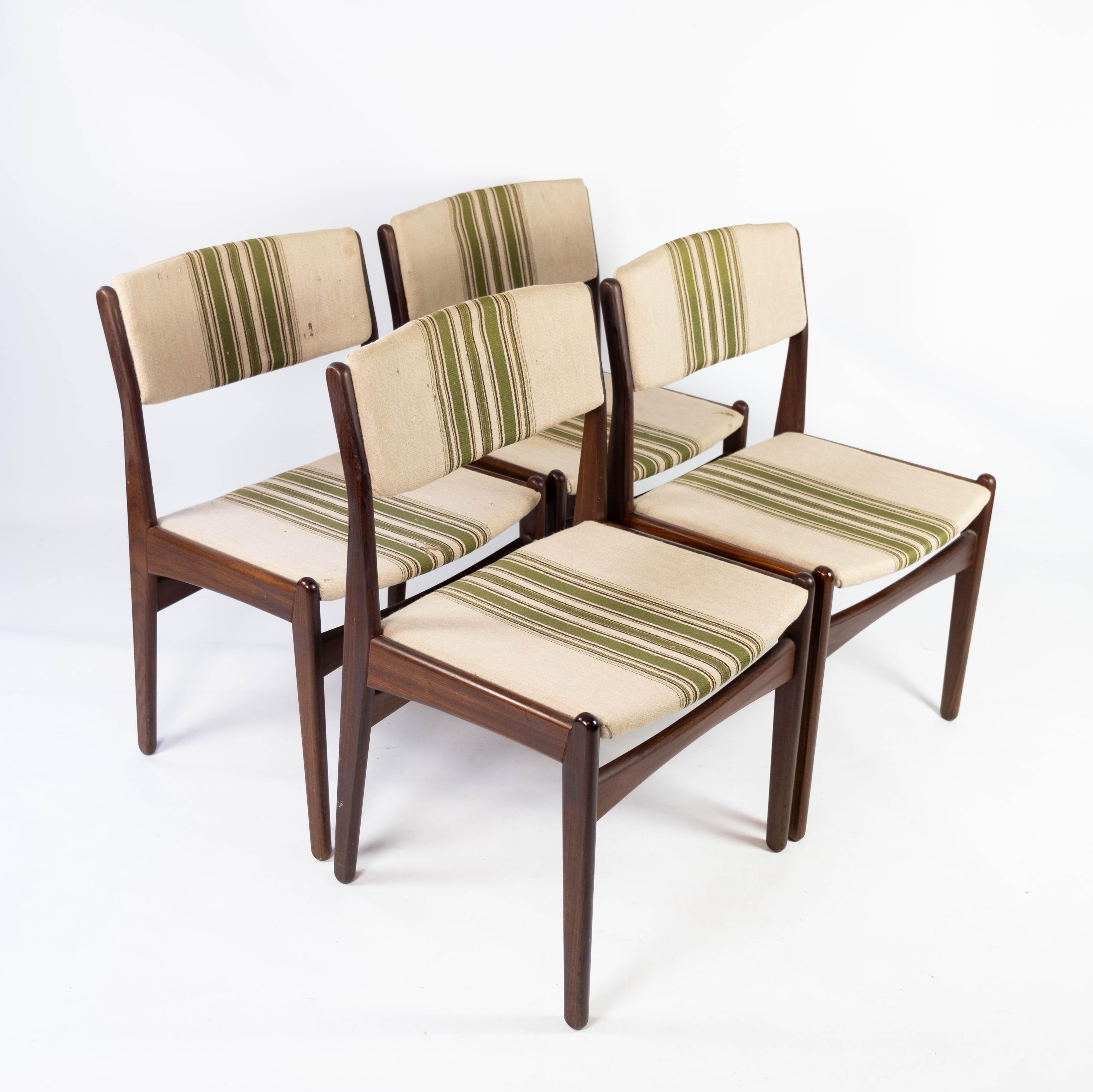 Set of four dining room chairs in teak and upholstered with striped fabric, designed by Erik Buch from the 1960s. The chairs are in great vintage condition.
 