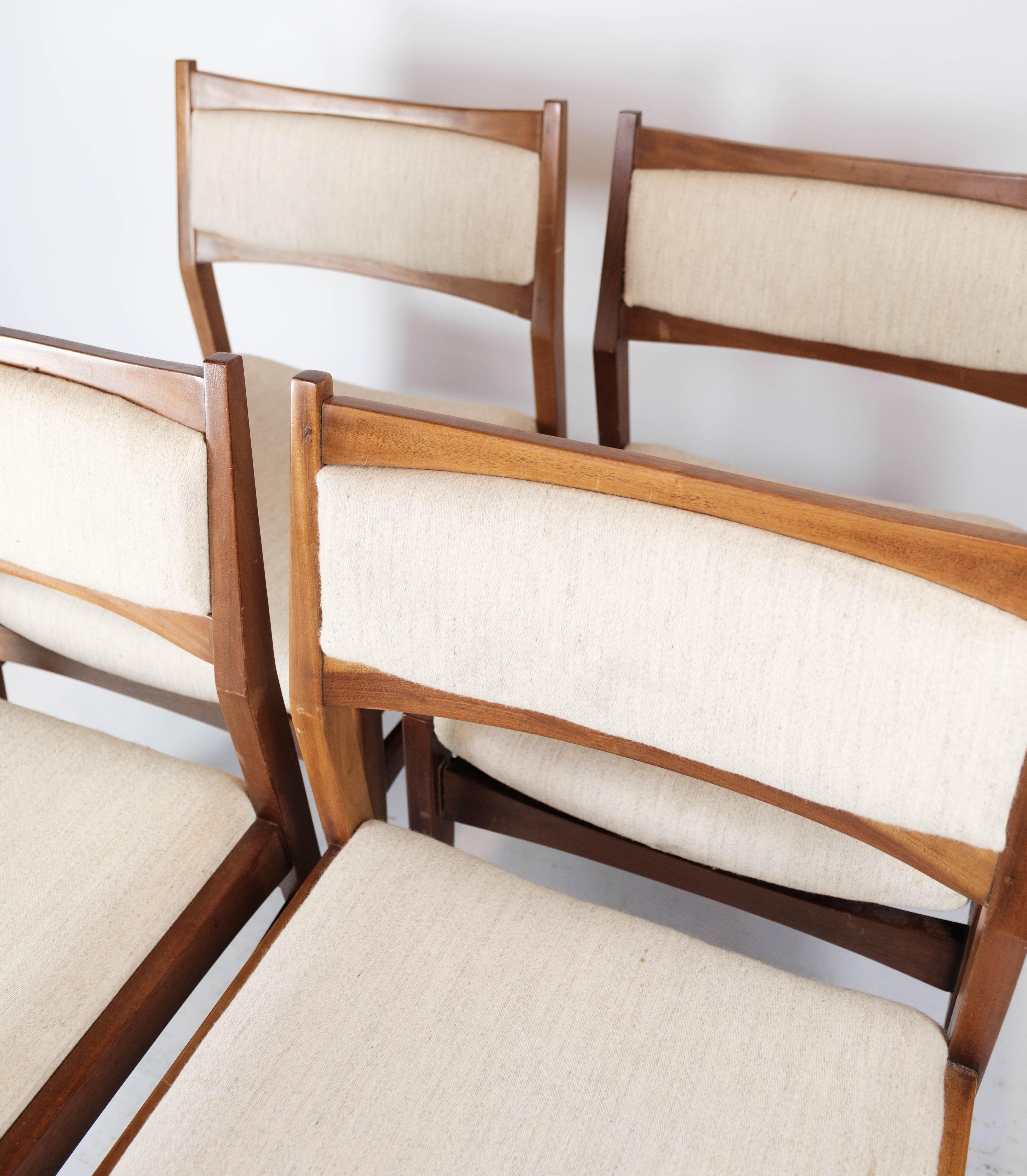 Set of four dining room chairs in teak and upholstered with light fabric, of Danish design from the 1960s. The chairs are in great vintage condition.