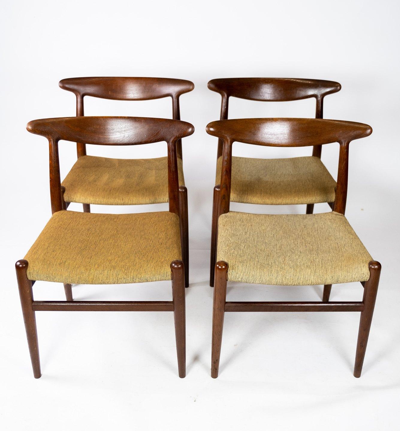 Set of four dining room chairs, model W2, designed by Hans J. Wegner from the 1960s. The chairs are of oak and upholstered with light fabric.
  