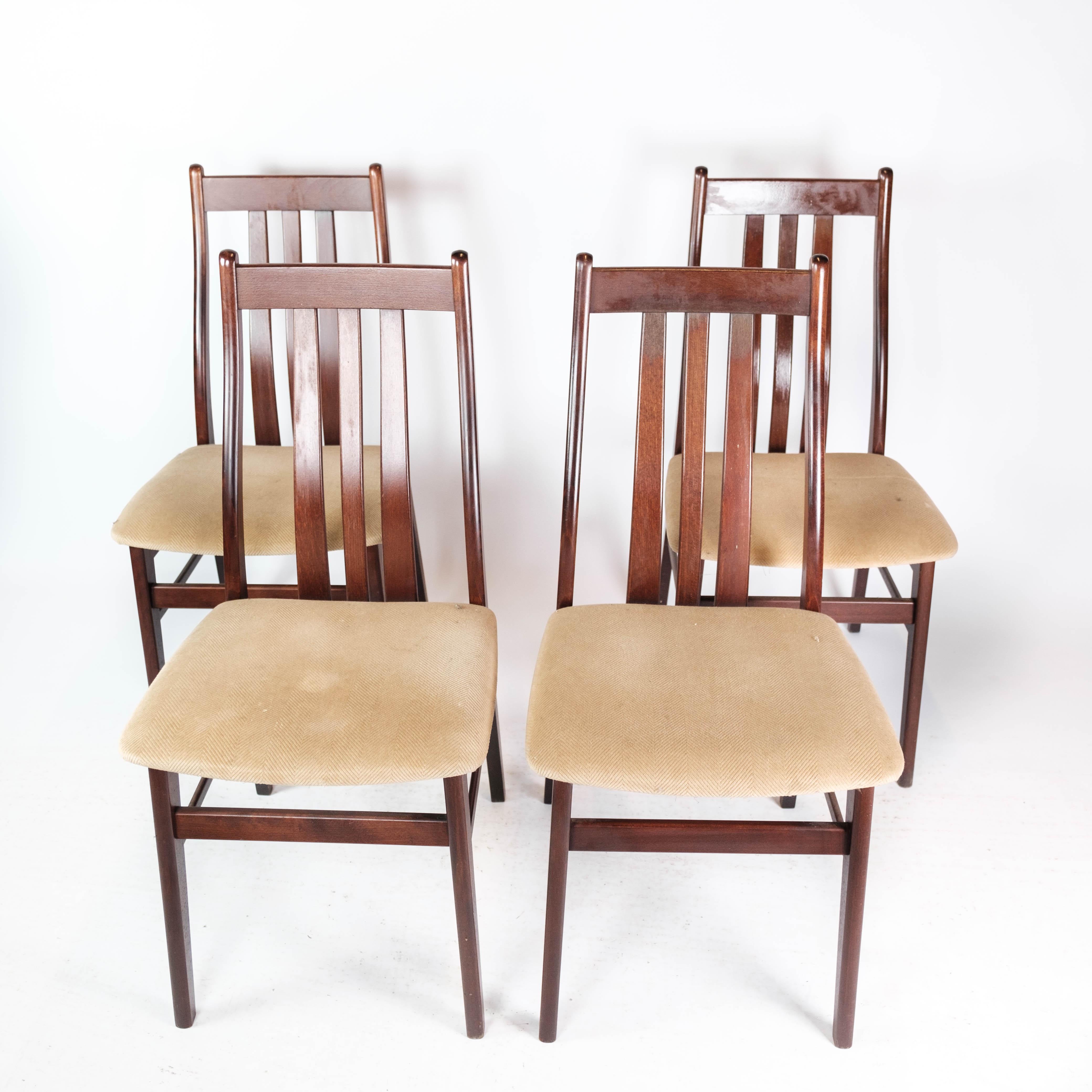 This set of four dining room chairs epitomizes the timeless elegance of Danish design from the 1960s. Crafted from exquisite mahogany wood, these chairs boast a rich and lustrous finish that adds warmth and sophistication to any dining space.

The