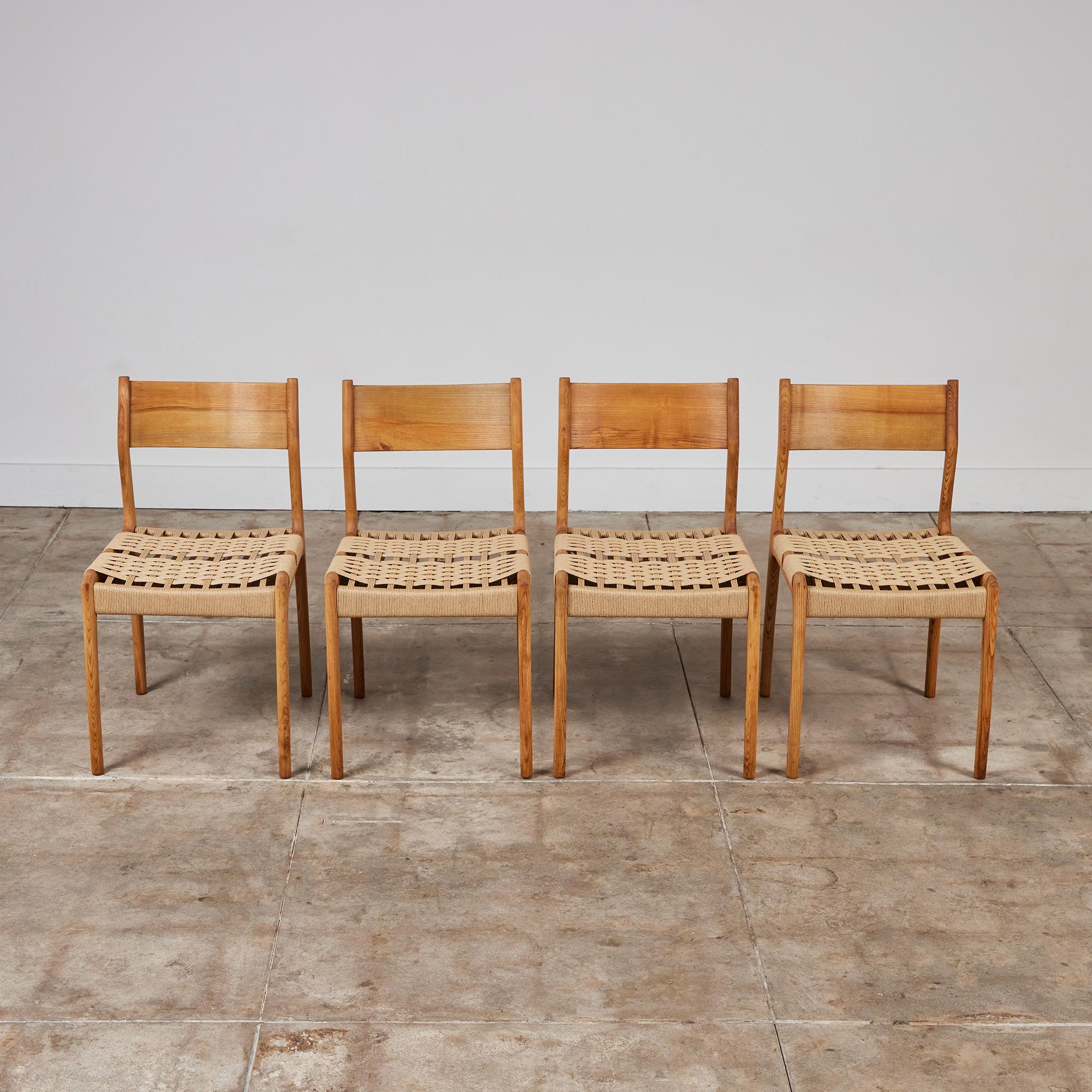 Set of four Italian side dining chairs by Consorzio Sedie Friuli c.1960s, Italy. The oak chairs feature a wide, curved backrest and hand woven seat in natural Danish paper cord.  

Dimensions
18